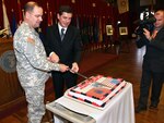 Maj. Gen. Glenn K. Rieth (left), the adjutant general of New Jersey and Mr. Gazmend Oketa (right), minister of defense for the republic of Albania, cut a special anniversary cake commemorating the 15-year partnership between New Jersey and the Republic of Albania in December. Oketa's visit coincides with the 15th anniversary of his nation's participation in the State Partnership Program with the New Jersey National Guard. This week, Albania achieved its long-standing goal of membership in the North Atlantic Treaty Organization.
