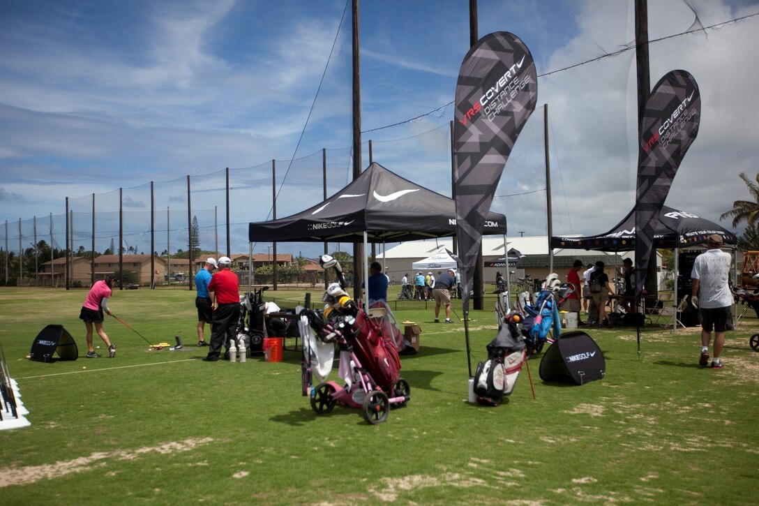 Representatives from golf companies like Nike and Titleist were on hand to help attendees pick a golf club and test it out during the fifth annual Klipper Summer Bash at Klipper Golf Course, July 26, 2013. The golf clubs were discounted and there were prize giveaways. The event was open to golfers and non-golfers, featuring longest drive contests and face painting, as well as food, drinks and music for everyone. Emily Vergara, an intermediate golfer, said she takes lessons on the course and the event is a great way to upgrade equipment and try clubs from various companies. (U.S. Marine Corps photo by Lance Cpl. Suzanna Knotts)