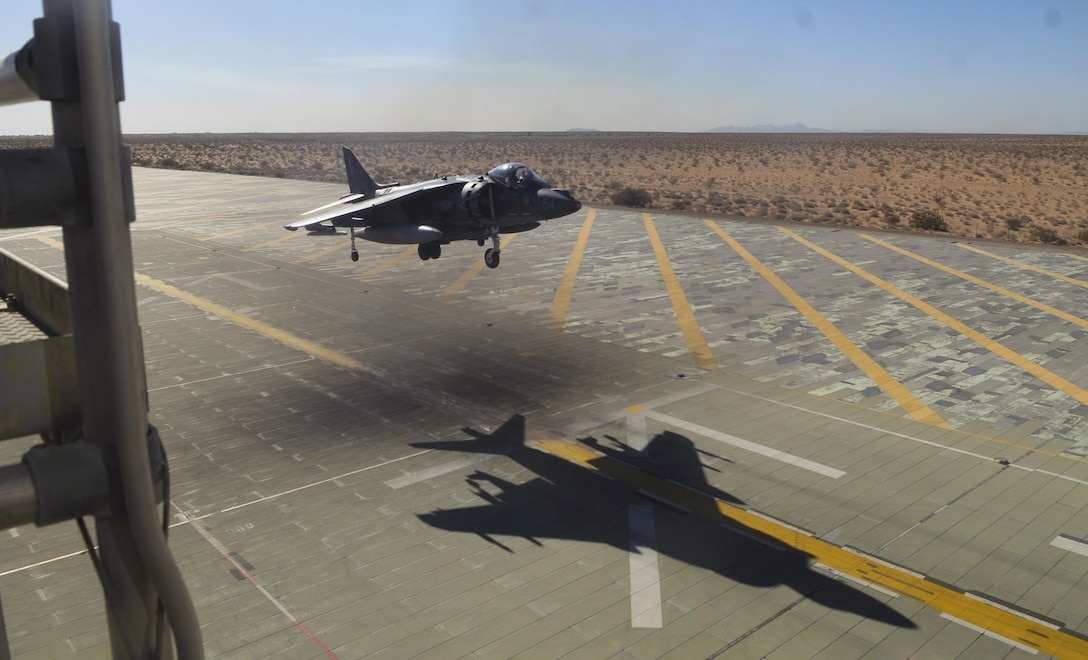 One of two VMA-214 AV-8B harriers reviews vertical landing procedures with the on-site systems tower to ensure mission readiness.  The field carrier imitation dock at Site 3-9, also known as AUX-II, 30 minutes out of Canon Air Defense Complex, serves as the ideal staging ground for Marine Attack Squadron 214 pilots to complete pre-deployment ship-based vertical landing certification.