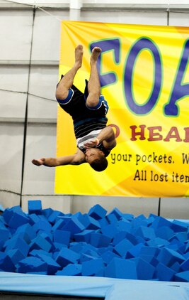 Sgt. Ruben Diaz, truck master, Aircraft, Rescue and Firefighting, Marine Corps Air Station Kaneohe Bay, launches from a trampoline and flips over into a pile of foam cubes at iTrampoline Hawaii in Kapolei, July 24, 2013. (U.S. Marine Corps photo by Jay Parco)