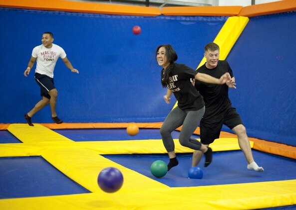 Cpl. Franklin Junay Lemus (left), administrative specialist, Marine Aircraft Group 24, Karley Peterson, coordinator, Single Marine and Sailor Program, and Cpl. David Cox, a communications technician at Marine Corps Air Station Kaneohe Bay, play a dodgeball game at iTrampoline Hawaii in Kapolei, July 24, 2013. (U.S. Marine Corps photo by Jay Parco)
