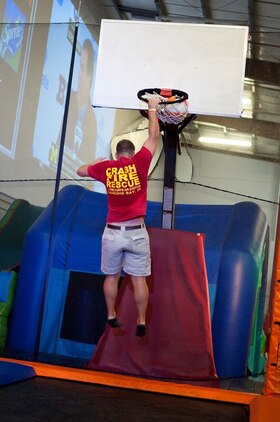 Cpl. Connor Knect, administrations chief, Aircraft, Rescue and Firefighting, Marine Corps Air Station Kaneohe Bay, attempts to make a basket while bouncing on a trampoline at iTrampoline Hawaii in Kapolei, July 24, 2013. (U.S. Marine Corps photo by Jay Parco)