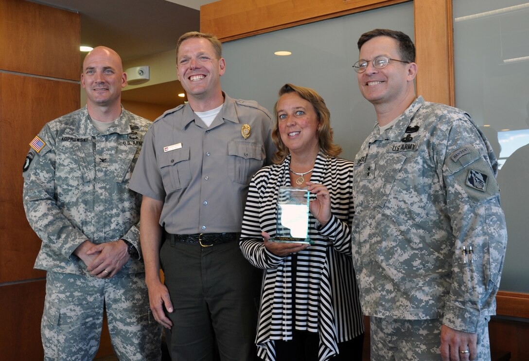 Maj. Gen. John Peabody (right), Mississippi Valley Division commander, presented a National Water Safety award to Carma Hanson, Grand Forks Safe Kids coordinator. Also in the photo is Col. Dan Koprowski (left), St. Paul District commander, and the person who nominated Hanson for this award, Scott Tichy, St. Paul District park ranger.