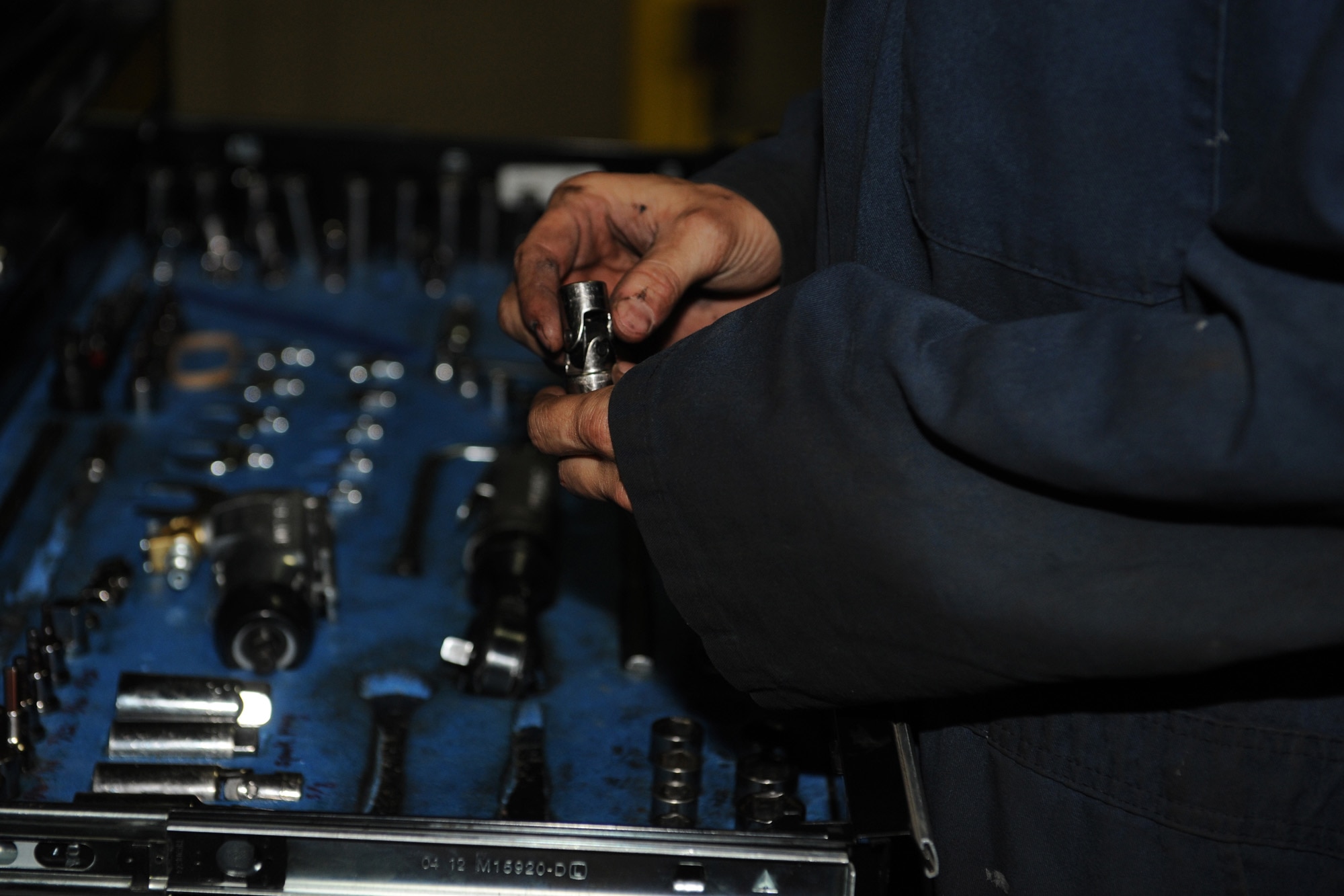 Airman 1st Class Garrett Barnes, 28th Logistics Readiness Squadron vehicle maintenance technician, puts a socket away after replacing a starter during scheduled maintenance on Ellsworth Air Force Base, S.D., July 25, 2013. Technicians work on up to five vehicles per day that range from scheduled inspections, engine, transmission, suspension replacement/rebuilds, brakes, accident repairs, welding and more. (U.S. Air Force photo by Airman 1st Class Rebecca Imwalle/Released)