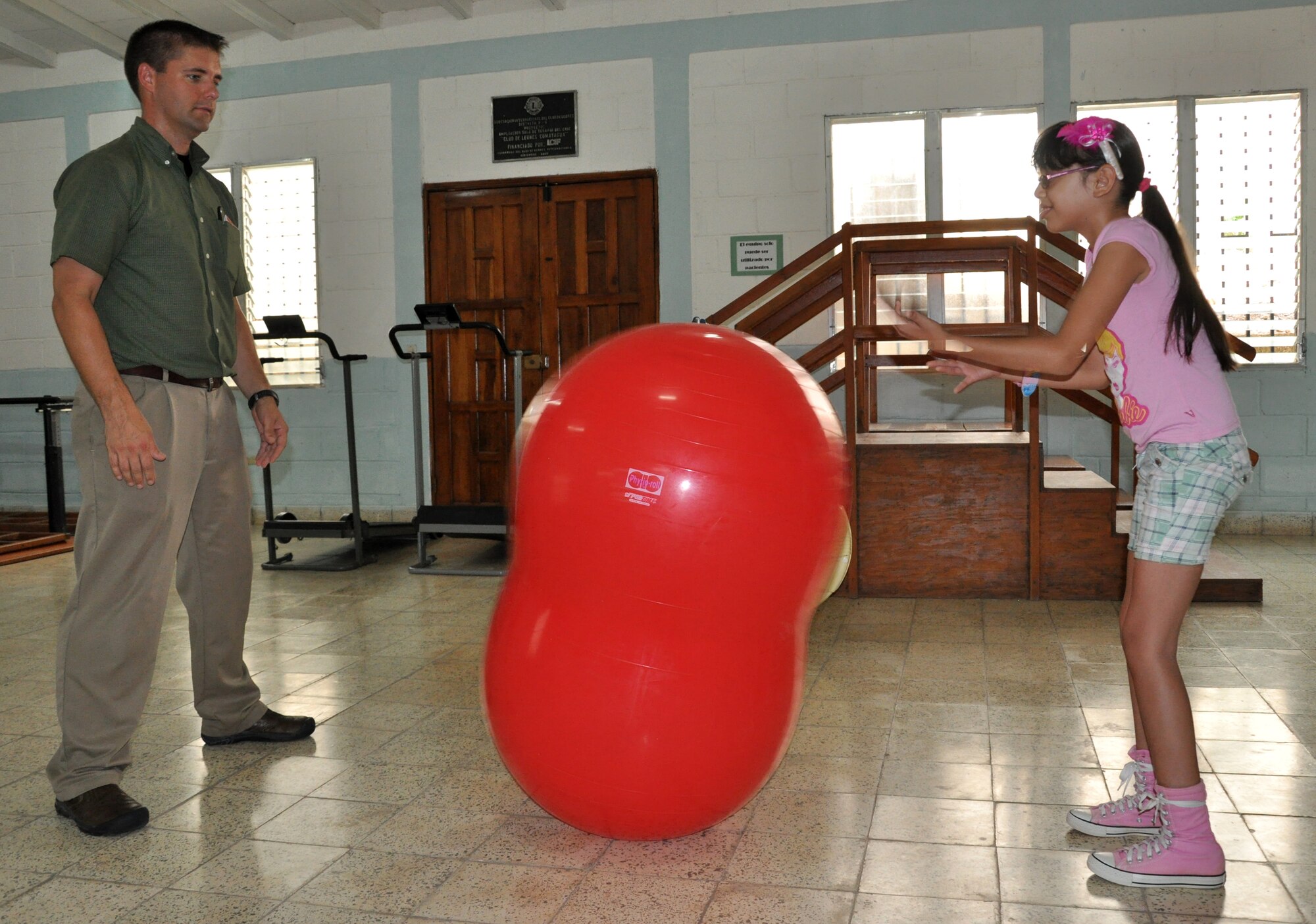 U.S. Army Capt. Joshua Brooks, Medical Element Physical Therapist officer-in-charge, uses an isokinetic peanut ball to help a young patient at the Comprehensive Rehabilitation Center in Comayagua, July 30, 2013. Physical therapists from MEDEL have helped more than 270 patients this year in part to help solidify the U.S. and Honduras ongoing partnerships and cooperation efforts.  