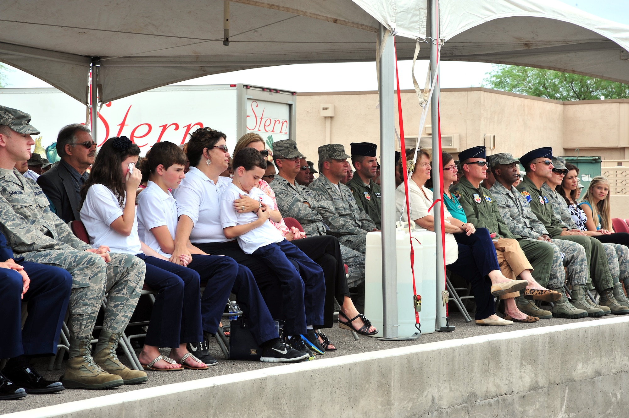 The Nylander family expresses emotion during the Nylander Building Dedication Ceremony at Davis-Monthan Air Force Base, Ariz., Aug. 1, 2013. The 25th Operational Weather Squadron was dedicated to Capt. Nathan Nylander, who died while deployed to Afghanistan in 2011. Nylander worked at the 25th OWS before his deployment. (U.S. Air Force Photo by Airman 1st Class Josh Slavin/Released)