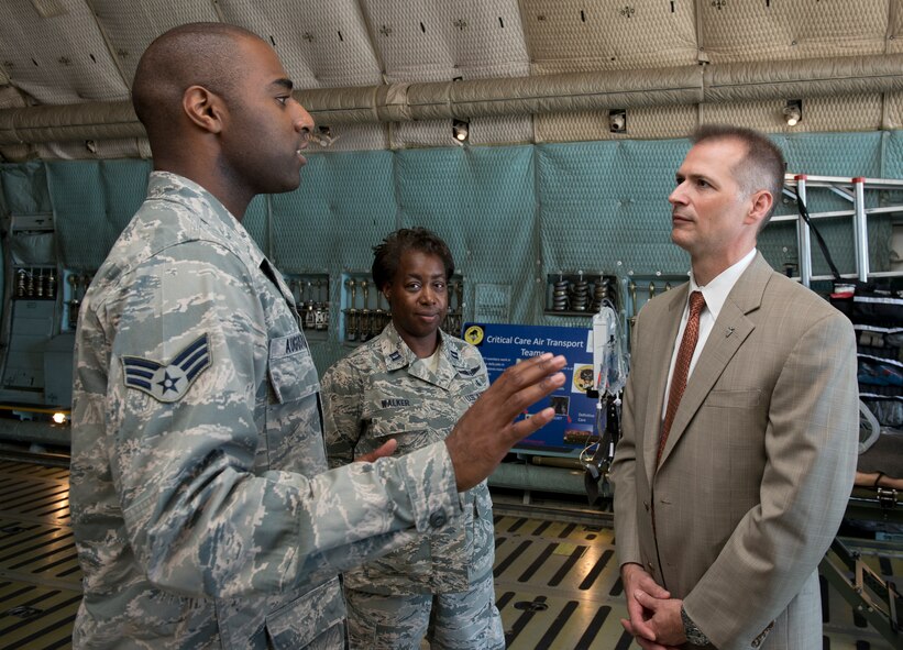 Senior Airman Gregory Augustin, 60th Aerospace Medicine Squadron, briefs Kevin Geiss, deputy assistant secretary of the Air Force for energy, about aeromedical evacuation aboard a C-5 Galaxy Wednesday morning. Geiss’ visit pertained to the installation safety, mission accomplishment, energy, logistics and fuel efficiency initiatives. (U.S. Air Force photo/ Heidi Couch)