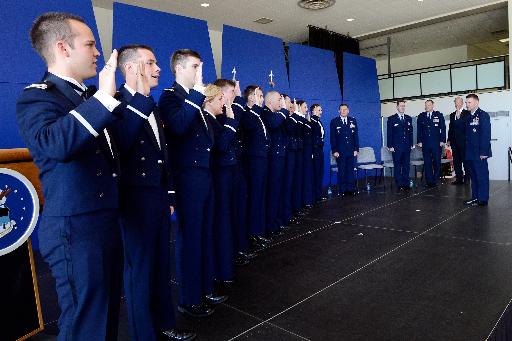 Brig. Gen. Greg Lengyel, right, administers the oath of office to 11 Air Force Academy cadets during a graduation and commissioning ceremony Aug. 2, 2013. A total of 1,035 cadets graduated in the Class of 2013, including 10 international graduates and five cross-commissioned officers. Lengyel is the Academy's commandant of cadets. (U.S. Air Force photo/Mike Kaplan)