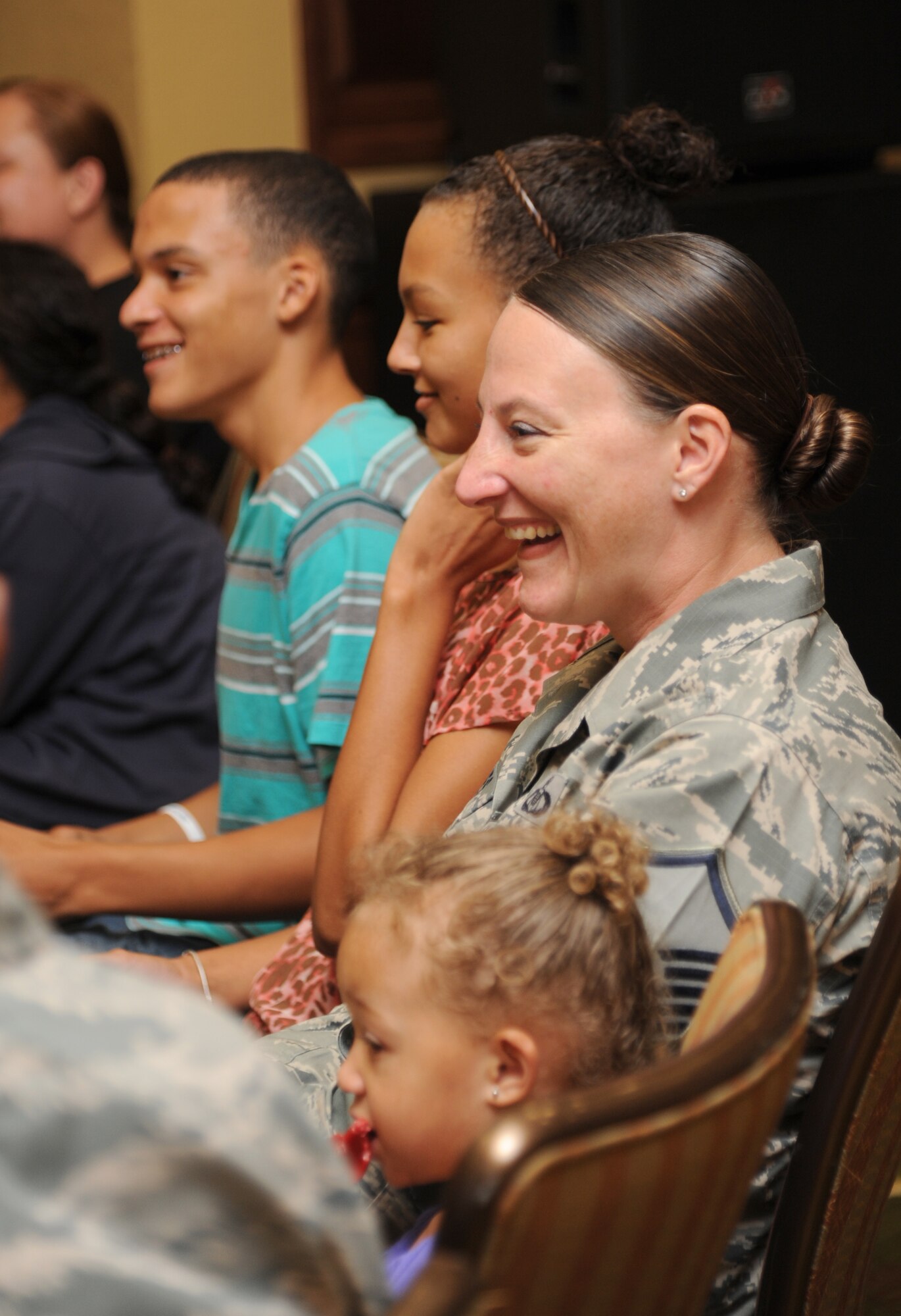Master Sgt. Laurie Holmes, 334th Training Squadron, and her children attend a “Can I Kiss You” presentation by Mike Domitrz, The Safe Date Project, Inc. founder, Aug. 1, 2013, at the Bay Breeze Event Center, Keesler Air Force Base, Miss.  The presentation, sponsored by the Keesler Sexual Assault Prevention and Response Office, provides parents, educators, students, military installations, community organizations, and others with resources, educational materials, and programs that address healthy intimacy, sexual assault awareness, and support for sexual assault survivors.  (U.S. Air Force photo by Kemberly Groue)