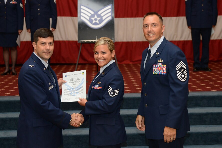 Staff Sgt. Jamie Walden, from the 96th Bomb Squadron, receives a certificate of promotion from Col. Andrew Gebara, 2nd Bomb Wing commander, and Chief Master Sgt. Curtis Storms, 2nd BW command chief, during the July Wing Promotion Ceremony on Barksdale Air Force Base, La., July 31, 2013. (U.S. Air Force photo)
