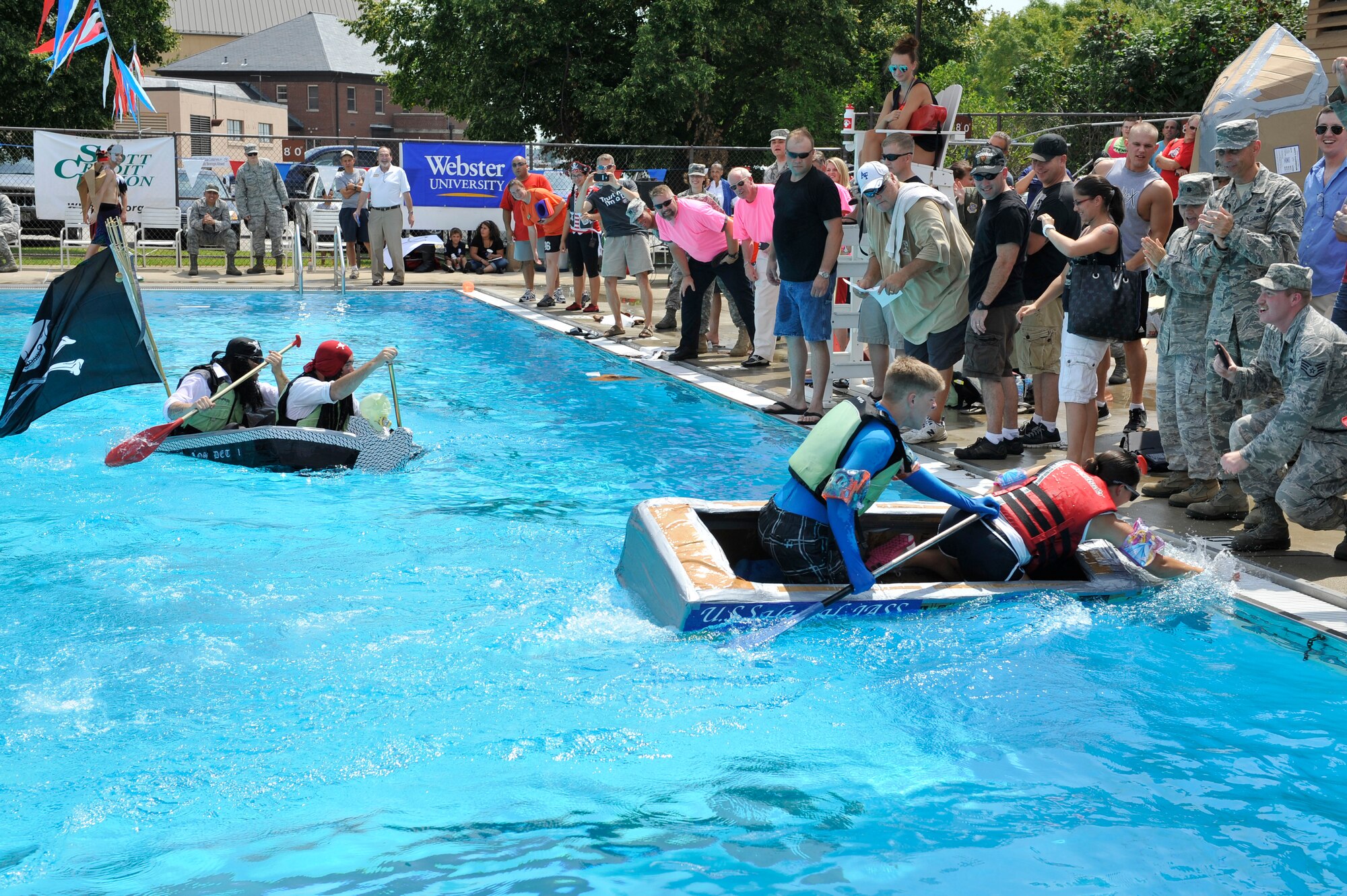Members from Team Scott participate in the 3rd annual Cardboard Boat Regatta at the Scott pool Aug. 2, 2013. The race, hosted by the 375 Force Support Squadron, featured 23 teams and gave away prizes for best decorated boat, fastest sinking boat and best dressed contestants. Gift cards were also given to the first, second and third place winners. (U.S. Air Force photo/Staff Sgt. Christopher Boitz)