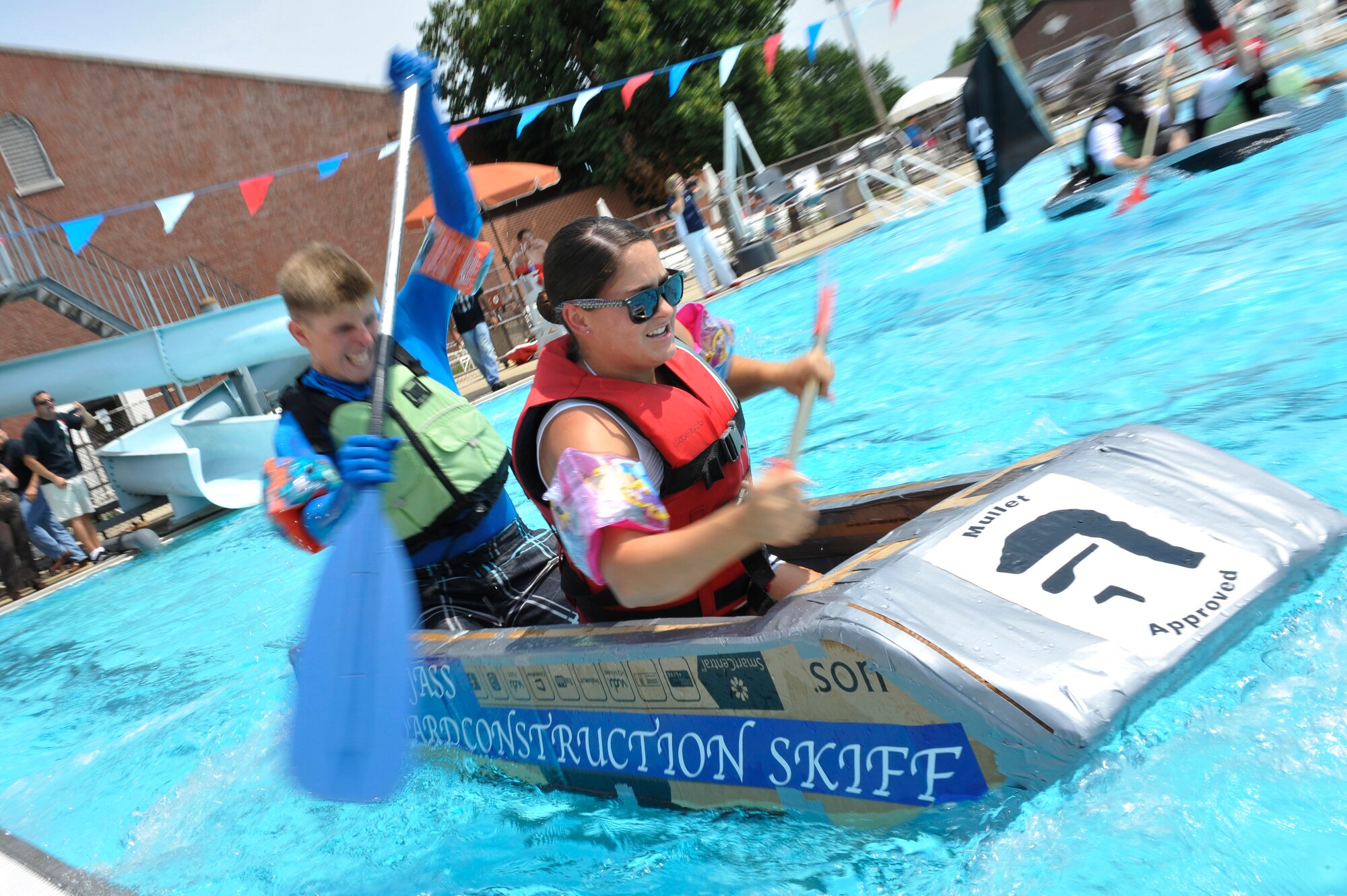 Members from Team Scott participate in the 3rd annual Cardboard Boat Regatta at the Scott pool Aug. 2, 2013. The race, hosted by the 375 Force Support Squadron, featured 23 teams and gave away prizes for best decorated boat, fastest sinking boat and best dressed contestants. Gift cards were also given to the first, second and third place winners. (U.S. Air Force photo/Staff Sgt. Christopher Boitz)
