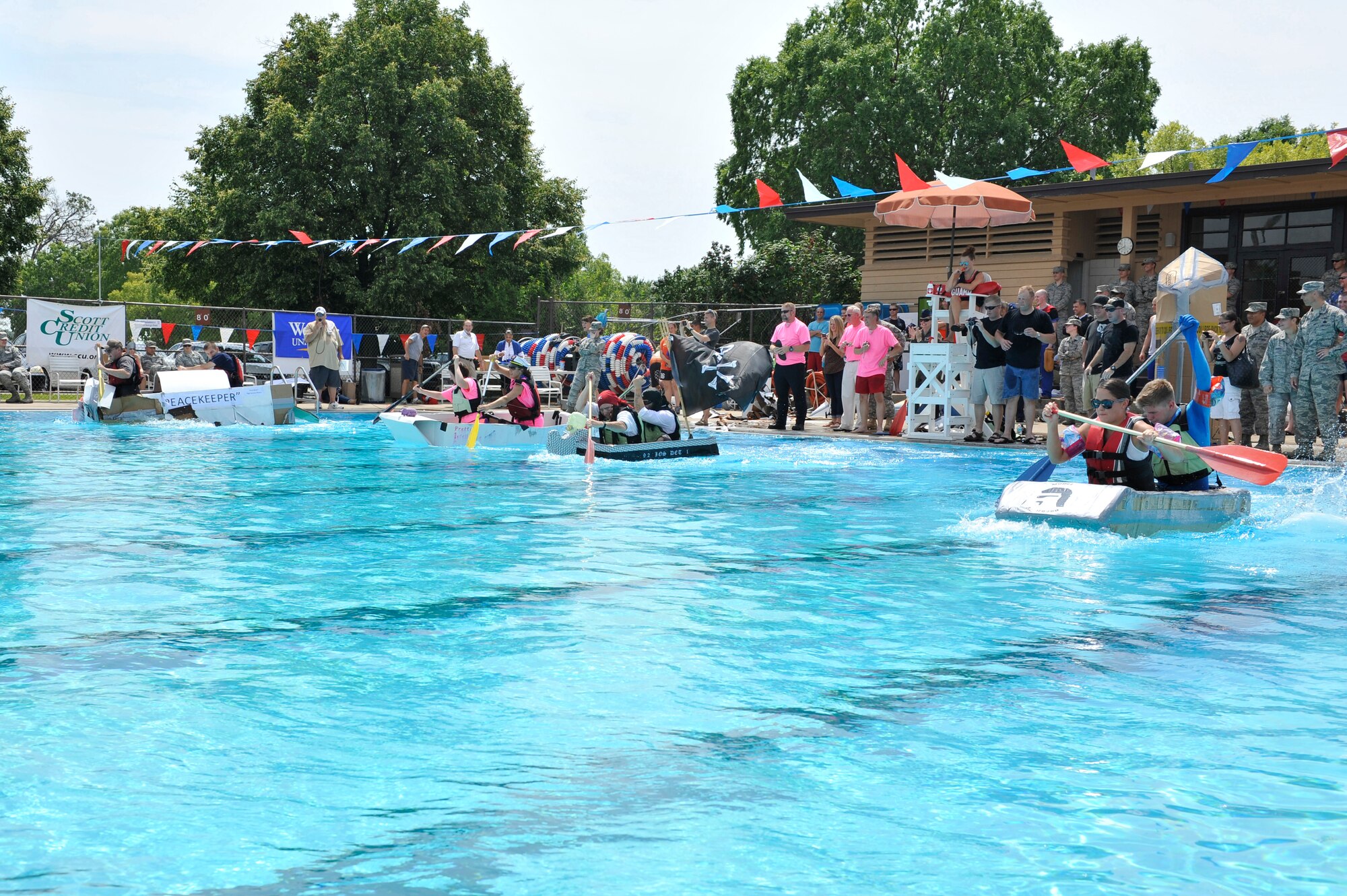 Members from Team Scott participate in the 3rd annual Cardboard Boat Regatta at the Scott pool Aug. 2, 2013. The race, hosted by the 375 Force Support Squadron, featured 23 teams and gave away prizes for best decorated boat, fastest sinking boat and best dressed contestants. Gift cards were also given to the first, second and third place winners. (U.S. Air Force photo/Staff Sgt. Christopher Boitz)