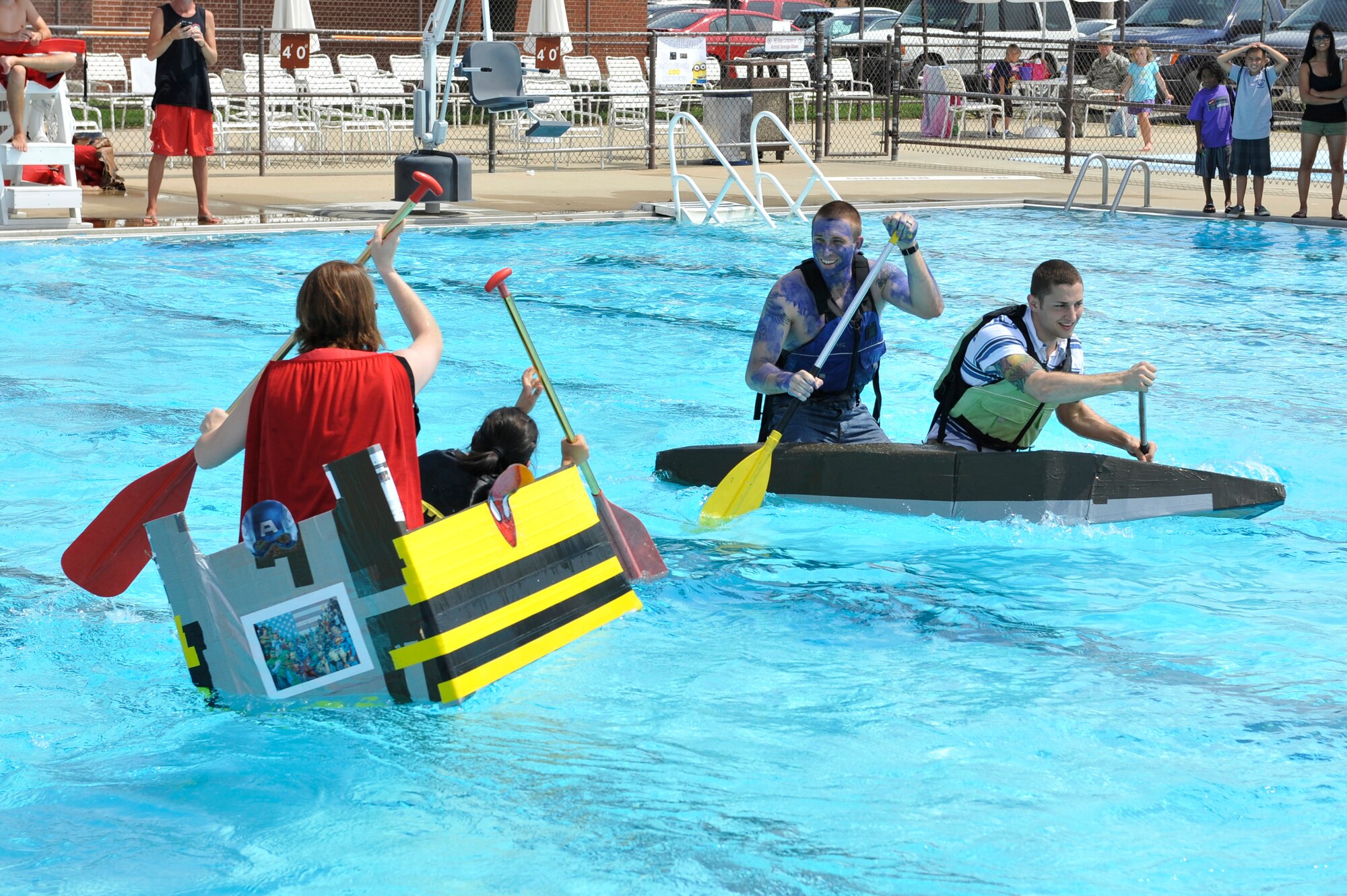 Members from Team Scott participate in the 3rd annual Cardboard Boat Regatta at the Scott pool Aug. 2, 2013. The race, hosted by the 375 Force Support Squadron, featured 23 teams and gave away prizes for best decorated boat, fastest sinking boat and best dressed contestants. Gift cards were also given to the first, second and third place winners. (U.S. Air Force photo/Staff Sgt. Christopher Boitz)