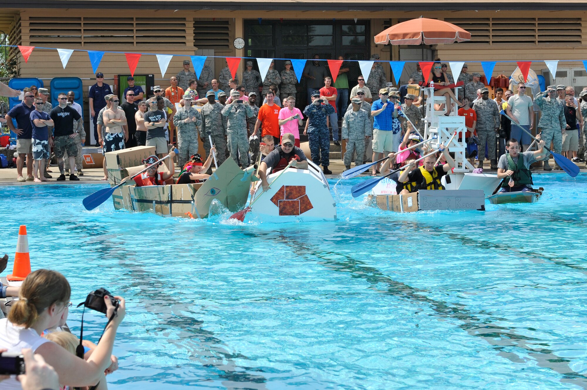Members from Team Scott participate in the 3rd annual Cardboard Boat Regatta at the Scott pool Aug. 2, 2013. The race, hosted by the 375 Force Support Squadron, featured 23 teams and gave away prizes for best decorated boat, fastest sinking boat and best dressed contestants. Gift cards were also given to the first, second and third place winners. (U.S. Air Force photo/Staff Sgt. Christopher Boitz)