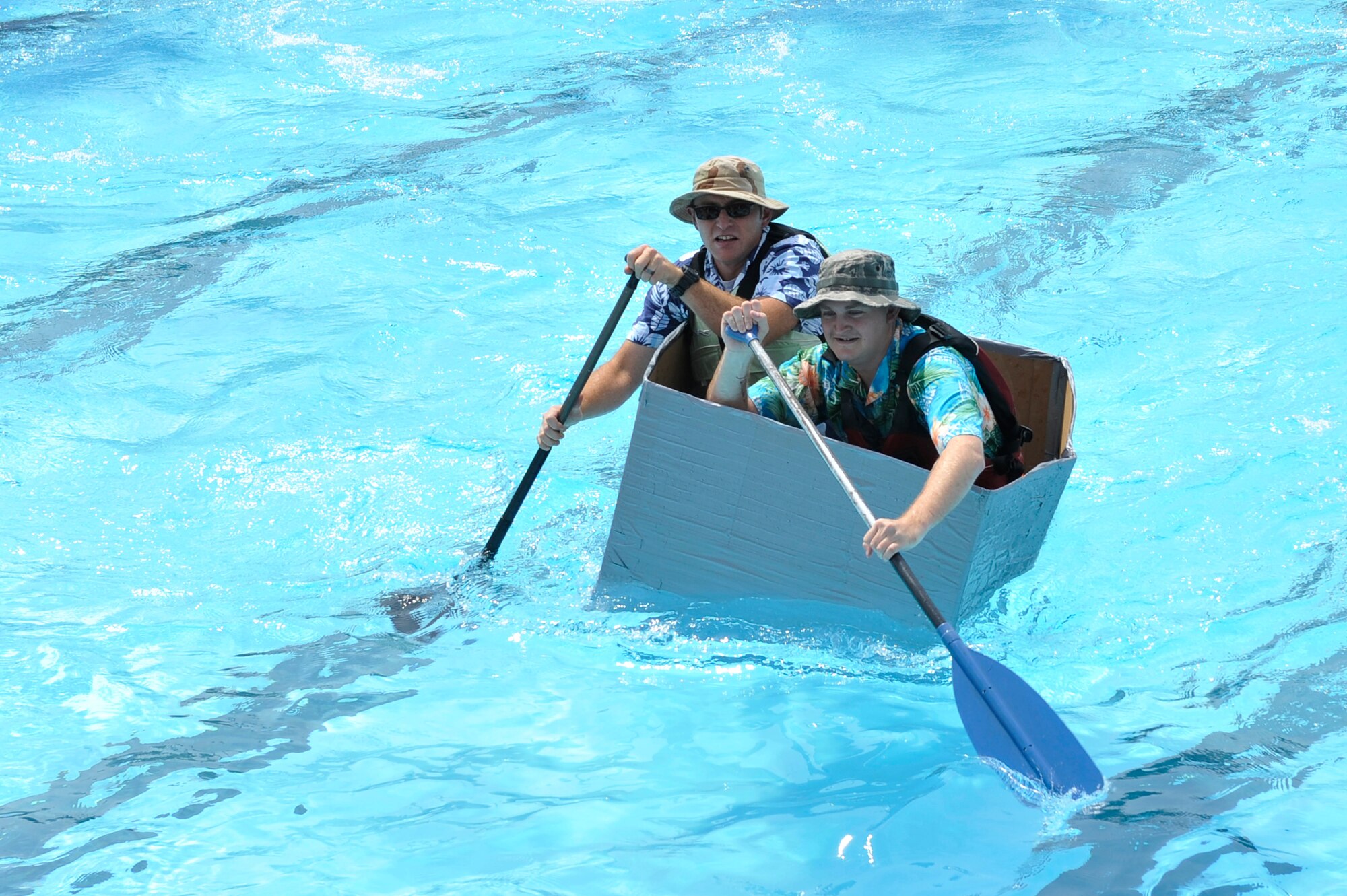 Members from Team Scott participate in the 3rd annual Cardboard Boat Regatta at the Scott pool Aug. 2, 2013. The race, hosted by the 375 Force Support Squadron, featured 23 teams and gave away prizes for best decorated boat, fastest sinking boat and best dressed contestants. Gift cards were also given to the first, second and third place winners. (U.S. Air Force photo/Staff Sgt. Christopher Boitz)
