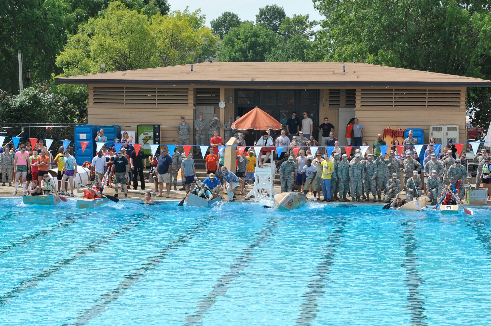 Members from Team Scott participate in the 3rd annual Cardboard Boat Regatta at the Scott pool Aug. 2, 2013. The race, hosted by the 375 Force Support Squadron, featured 23 teams and gave away prizes for best decorated boat, fastest sinking boat and best dressed contestants. Gift cards were also given to the first, second and third place winners. (U.S. Air Force photo/Staff Sgt. Christopher Boitz)