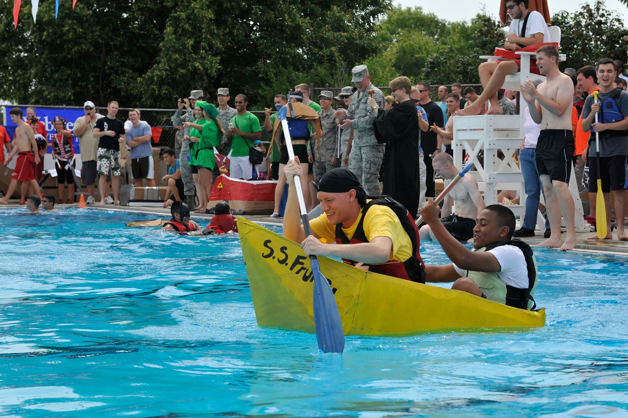 Members from Team Scott participate in the 3rd annual Cardboard Boat Regatta at the Scott pool Aug. 2, 2013. The race, hosted by the 375 Force Support Squadron, featured 23 teams and gave away prizes for best decorated boat, fastest sinking boat and best dressed contestants. Gift cards were also given to the first, second and third place winners. (U.S. Air Force photo/Staff Sgt. Christopher Boitz)