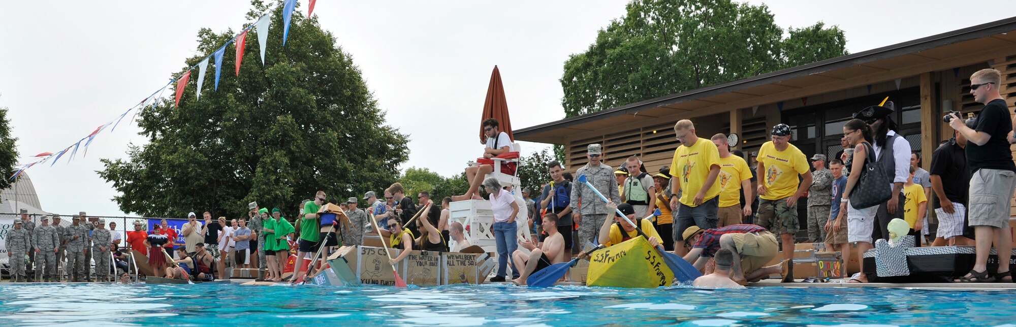Members from Team Scott participate in the 3rd annual Cardboard Boat Regatta at the Scott pool Aug. 2, 2013. The race, hosted by the 375 Force Support Squadron, featured 23 teams and gave away prizes for best decorated boat, fastest sinking boat and best dressed contestants. Gift cards were also given to the first, second and third place winners. (U.S. Air Force photo/Staff Sgt. Christopher Boitz)
