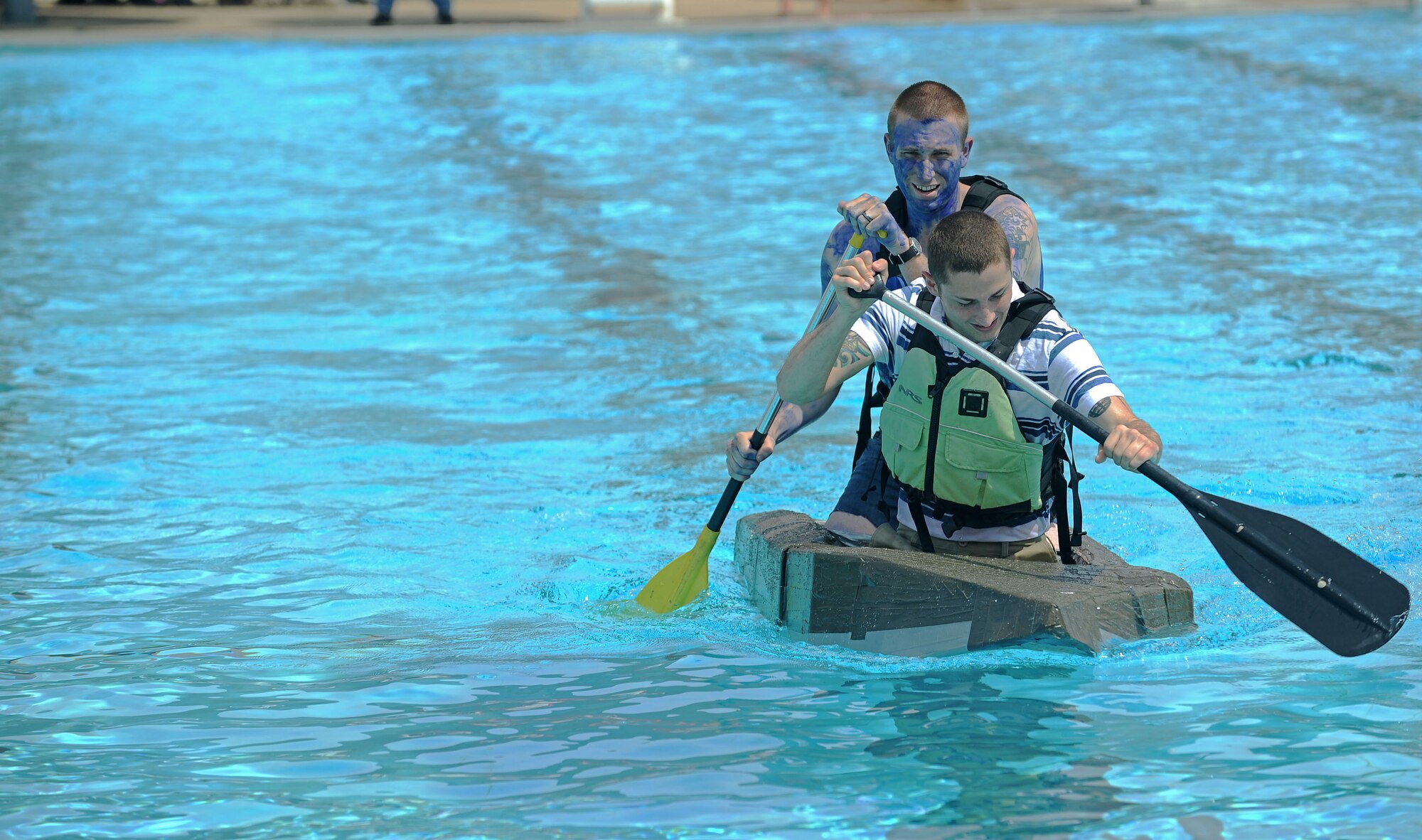 Members from Team Scott participate in the 3rd annual Cardboard Boat regatta at the Scott pool Aug. 2, 2013. The race, hosted by the 375th Force Support Squadron, featured 23 teams and gave away prizes for the best decorated boat, faster sinking boat and best dressed contestants.  Gift cards were also given to the first, second and third place winners. (U.S. Air Force photo/Senior Airman Divine Cox)