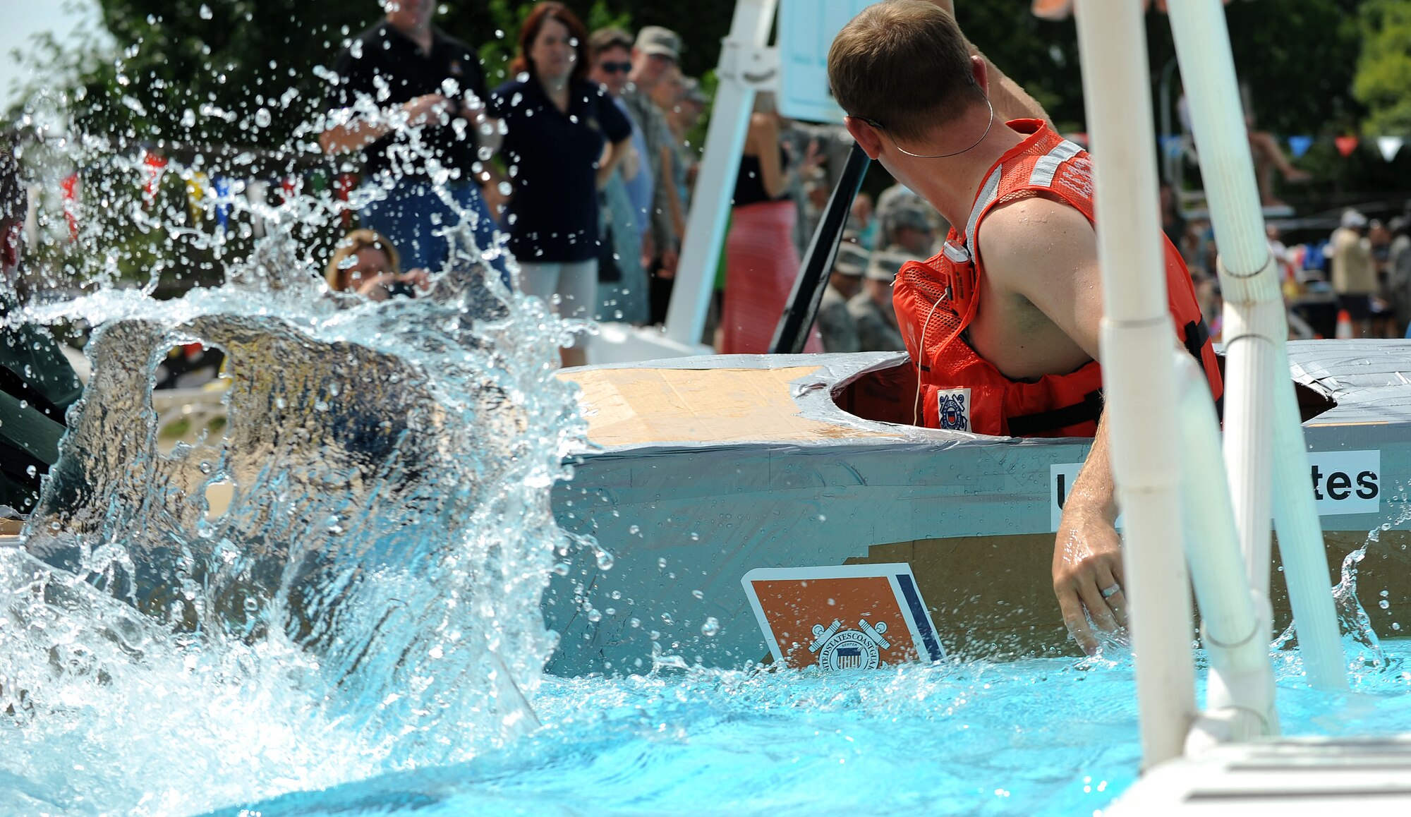 Members from Team Scott participate in the 3rd annual Cardboard Boat regatta at the Scott pool Aug. 2, 2013. The race, hosted by the 375th Force Support Squadron, featured 23 teams and gave away prizes for the best decorated boat, faster sinking boat and best dressed contestants.  Gift cards were also given to the first, second and third place winners. (U.S. Air Force photo/Senior Airman Divine Cox)