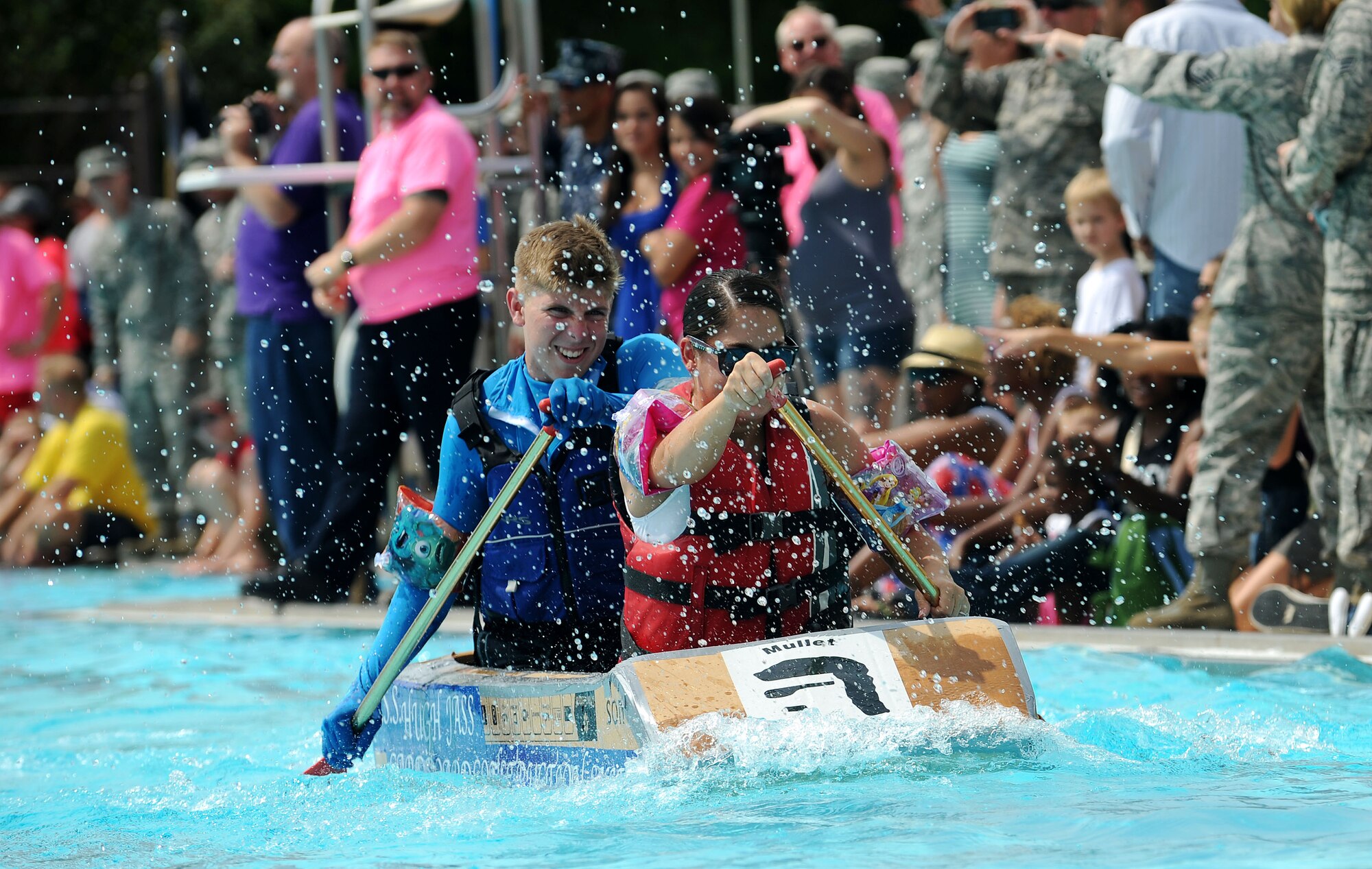 Members from Team Scott participate in the 3rd annual Cardboard Boat regatta at the Scott pool Aug. 2, 2013. The race, hosted by the 375th Force Support Squadron, featured 23 teams and gave away prizes for the best decorated boat, faster sinking boat and best dressed contestants.  Gift cards were also given to the first, second and third place winners. (U.S. Air Force photo/Senior Airman Divine Cox)