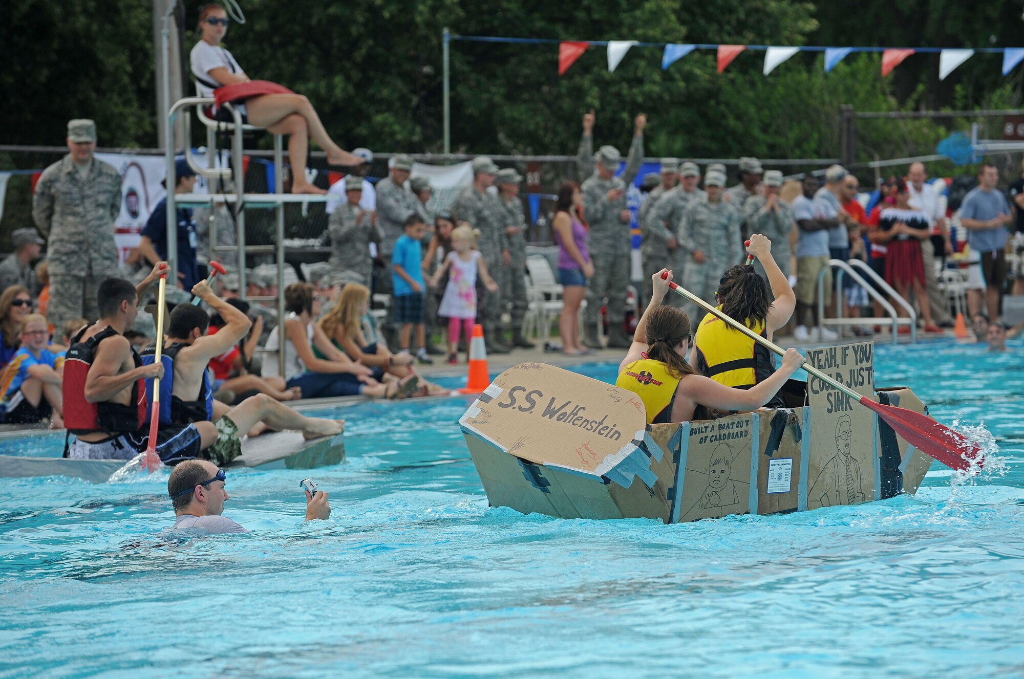 Members from Team Scott participate in the 3rd annual Cardboard Boat regatta at the Scott pool Aug. 2, 2013. The race, hosted by the 375th Force Support Squadron, featured 23 teams and gave away prizes for the best decorated boat, faster sinking boat and best dressed contestants.  Gift cards were also given to the first, second and third place winners. (U.S. Air Force photo/Senior Airman Divine Cox)