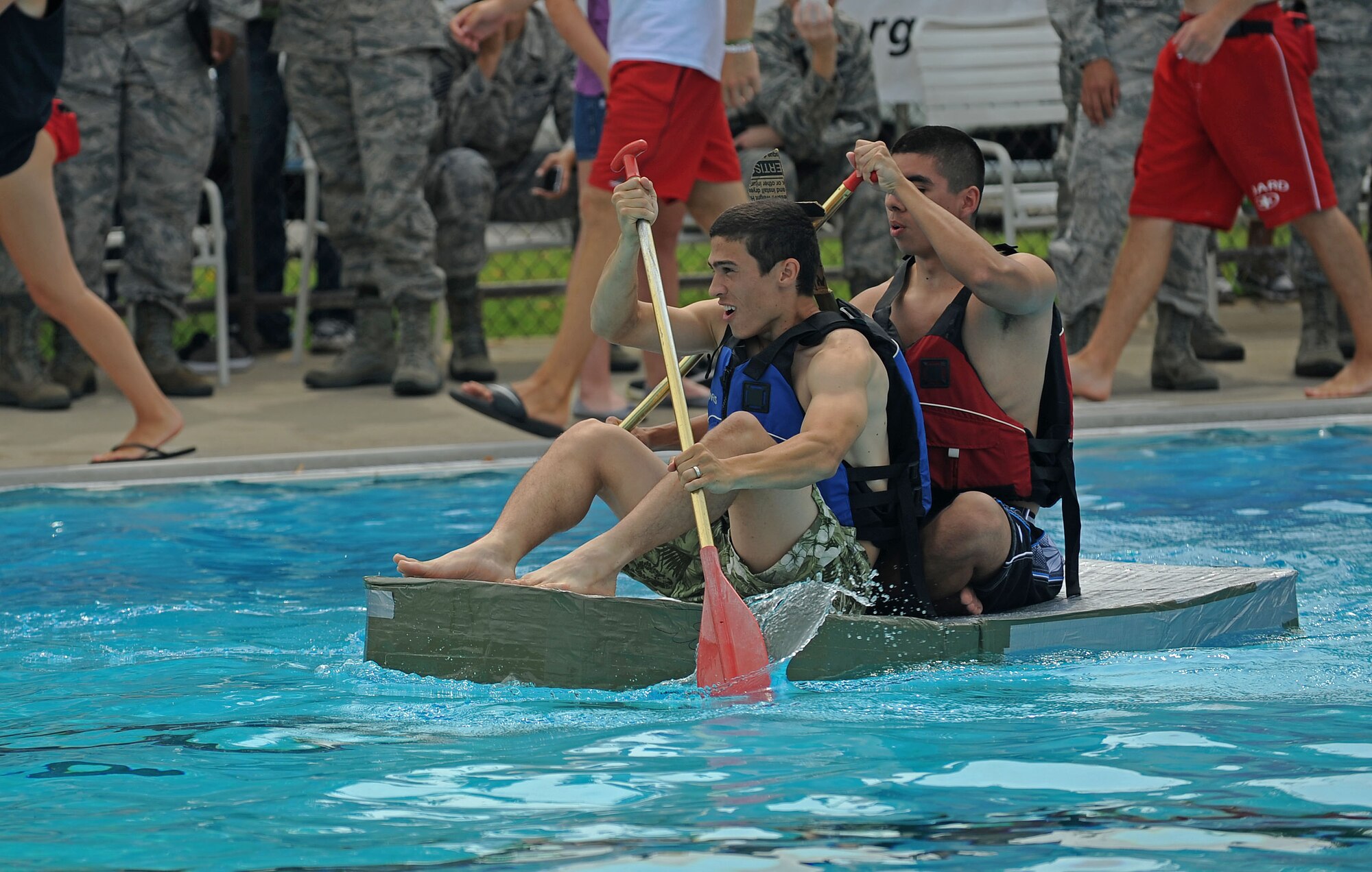 Members from Team Scott participate in the 3rd annual Cardboard Boat regatta at the Scott pool Aug. 2, 2013. The race, hosted by the 375th Force Support Squadron, featured 23 teams and gave away prizes for the best decorated boat, faster sinking boat and best dressed contestants.  Gift cards were also given to the first, second and third place winners. (U.S. Air Force photo/Senior Airman Divine Cox)