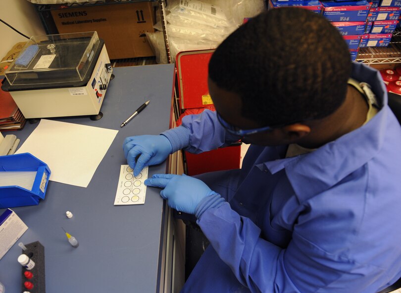 Staff Sgt. Christopher Hearst, 2nd Medical Support Squadron laboratory technician, places a blood sample on a rapid plasma reagin test card on Barksdale Air Force Base, La., Aug. 2, 2013. The RPR test checks for antibodies inside the blood that may determine whether someone has a specific disease. (U.S. Air Force photo/Senior Airman Benjamin Gonsier)
