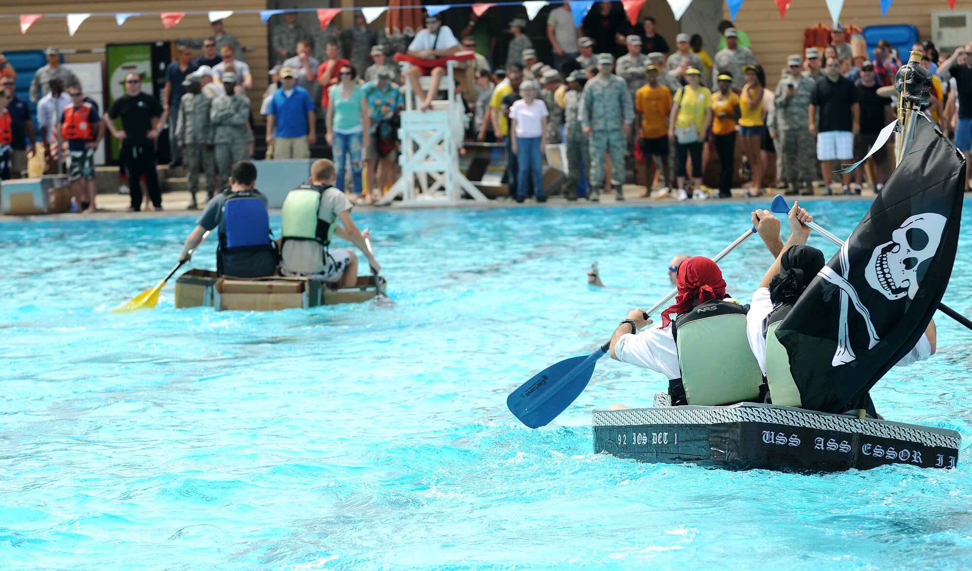 Members from Team Scott participate in the 3rd annual Cardboard Boat regatta at the Scott pool Aug. 2, 2013. The race, hosted by the 375th Force Support Squadron, featured 23 teams and gave away prizes for the best decorated boat, faster sinking boat and best dressed contestants.  Gift cards were also given to the first, second and third place winners. (U.S. Air Force photo/Senior Airman Divine Cox)