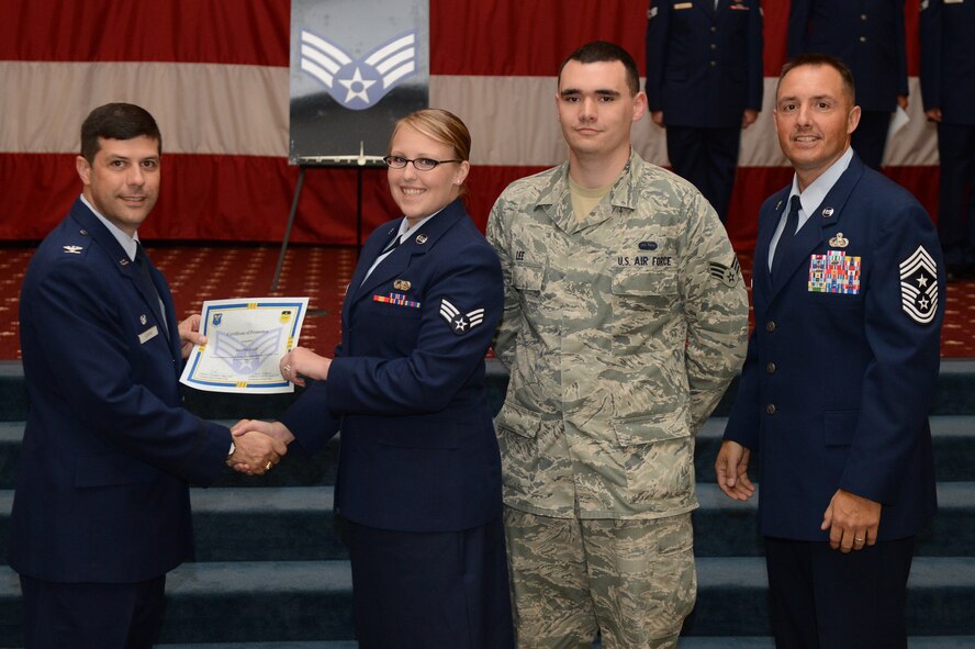 Senior Airman Amanda Lee, from the 2nd Communication Squadron, receives a certificate of promotion from Col. Andrew Gebara, 2nd Bomb Wing commander, and Chief Master Sgt. Curtis Storms, 2nd BW command chief, during the July Wing Promotion Ceremony on Barksdale Air Force Base, La., July 31, 2013. (U.S. Air Force photo/Senior Airman Micaiah Anthony)