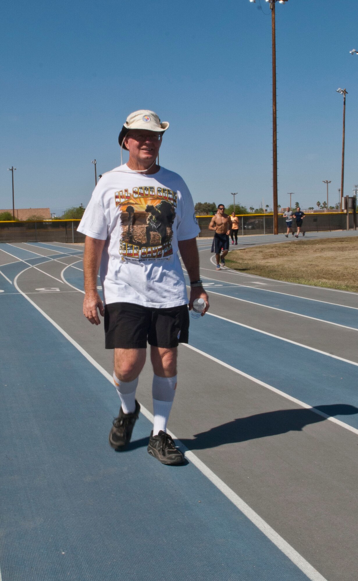 Retired Chief Master Sgt. Barry Lewis walks around the track during the Viking Challenge April 5 at the Luke Air Force Base track. Lewis walked during the 10-hour event in preparation for walking from Phoenix to his home town of Fredericktown, Penn. (U.S. Air Force photo/Senior Airman David Owsianka)