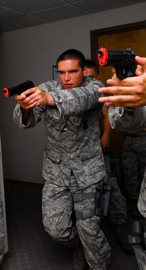 Airman 1st Class Curtis Varner, 56th SFS patrolman, moves toward the room where simulated gun fire was sounded during an active-shooter exercise June 28 at Luke Air Force Base. (U.S. Air Force photo/Senior Airman David Owsianka)
