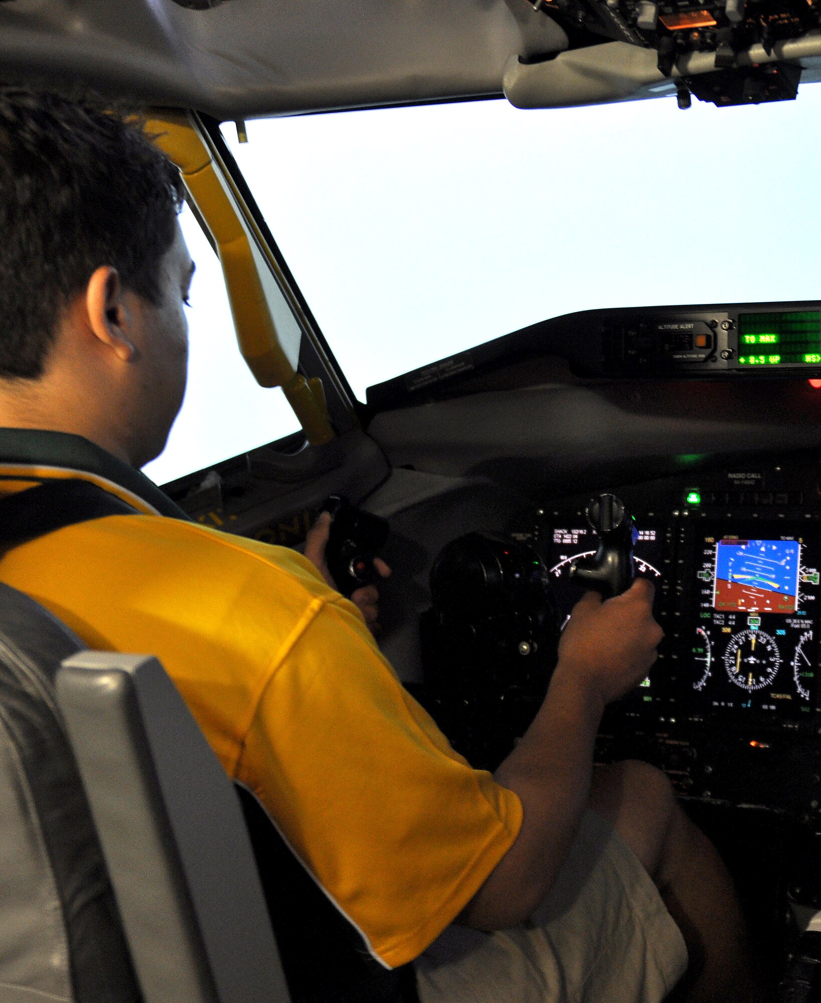 Brody Johnson, an air cadet visiting the U.S. from Australia as part of the International Air Cadet Exchange program, pilots an RC-135 Rivet Joint aircraft simulator at Offutt Air Force Base, Neb., July 31. The cadets each took turns piloting the aircraft simulator where they practiced takeoffs and landings. The cadets, who are from Turkey, the United Kingdom and Australia, were selected from thousands of cadets worldwide to participate in the program. (U.S. Air Force photo by Jeff Gates/Released)