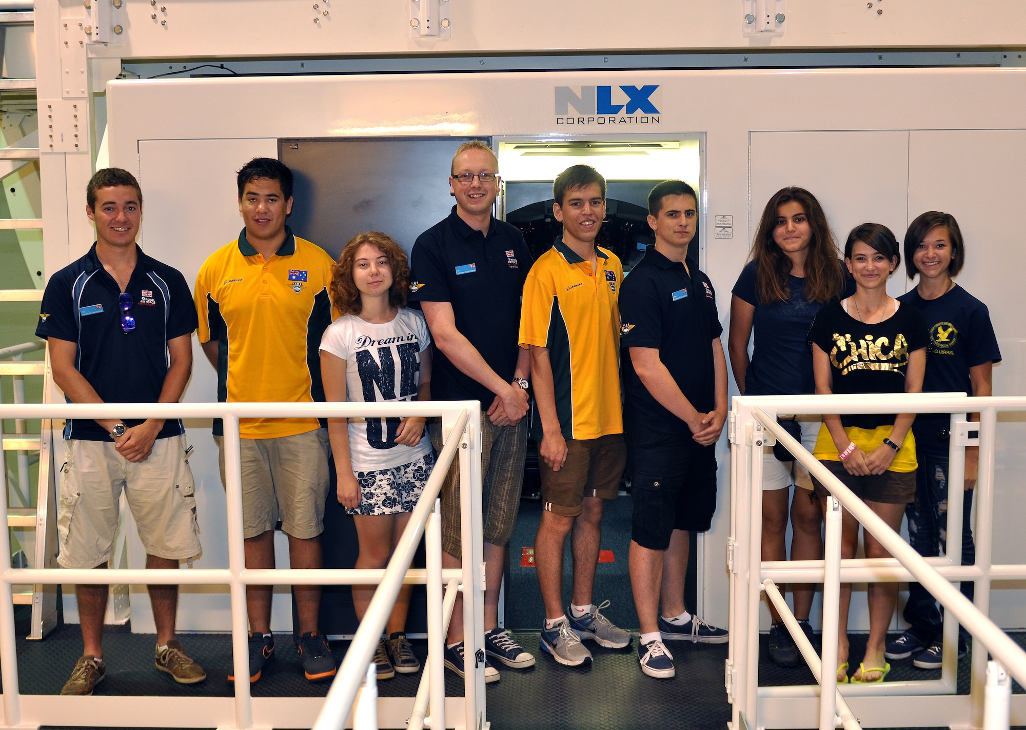 Air cadets from the International Air Cadet Exchange program pose for a photograph on the platform of an RC-135 Rivet Joint aircraft simulator at Offutt Air Force Base, Neb., July 31. The cadets each took turns piloting the aircraft simulator where they practiced takeoffs and landings. The cadets, who are from Turkey, the United Kingdom and Australia, were selected from thousands of cadets worldwide to participate in the program. (U.S. Air Force photo by Jeff Gates/Released)