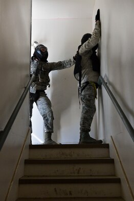 Senior Airman Derrick Corns, 56th SFS patrolman, searches Staff Sgt. Robert Degoey, 56th SFS, after apprehending him while clearing the building of suspects. (U.S. Air Force photo/Senior Airman David Owsianka)