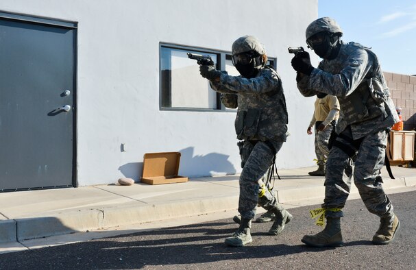 Airmen from the 56th SFS move toward a building with a simulated active shooter inside July 24 during an active-shooter training exercise at the Phoenix Police Academy shoot house. The Airmen had to clear a building of suspects and hostages (U.S. Air Force photo/Senior Airman David Owsianka)