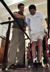 U.S. Army Capt. Joshua Brooks, Medical Element Physical Therapist officer-in-charge, uses the parallel bars to help a patient at the Comprehensive Rehabilitation Center in Comayagua, July 30, 2013. Physical therapists from MEDEL have helped more than 270 patients this year in part to help solidify the U.S. and Honduras ongoing partnerships and cooperation efforts.  