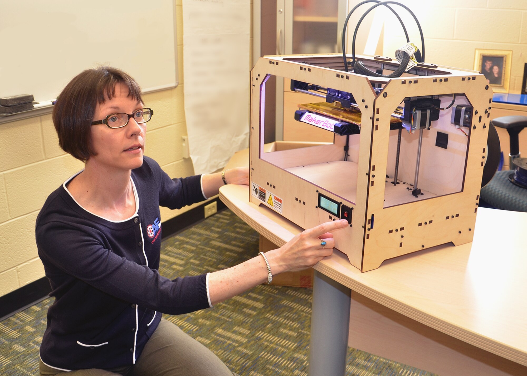Dr. Mary Kinsella, an Air Force Research Laboratory materials and manufacturing research engineer, demonstrates the use of a desktop 3-D printer.  3-D printing, or additive manufacturing, is a focus of Air Force research for design iteration, prototyping, tooling and fixtures and for some noncritical parts. (U.S. Air Force photo by Lori Hughes)