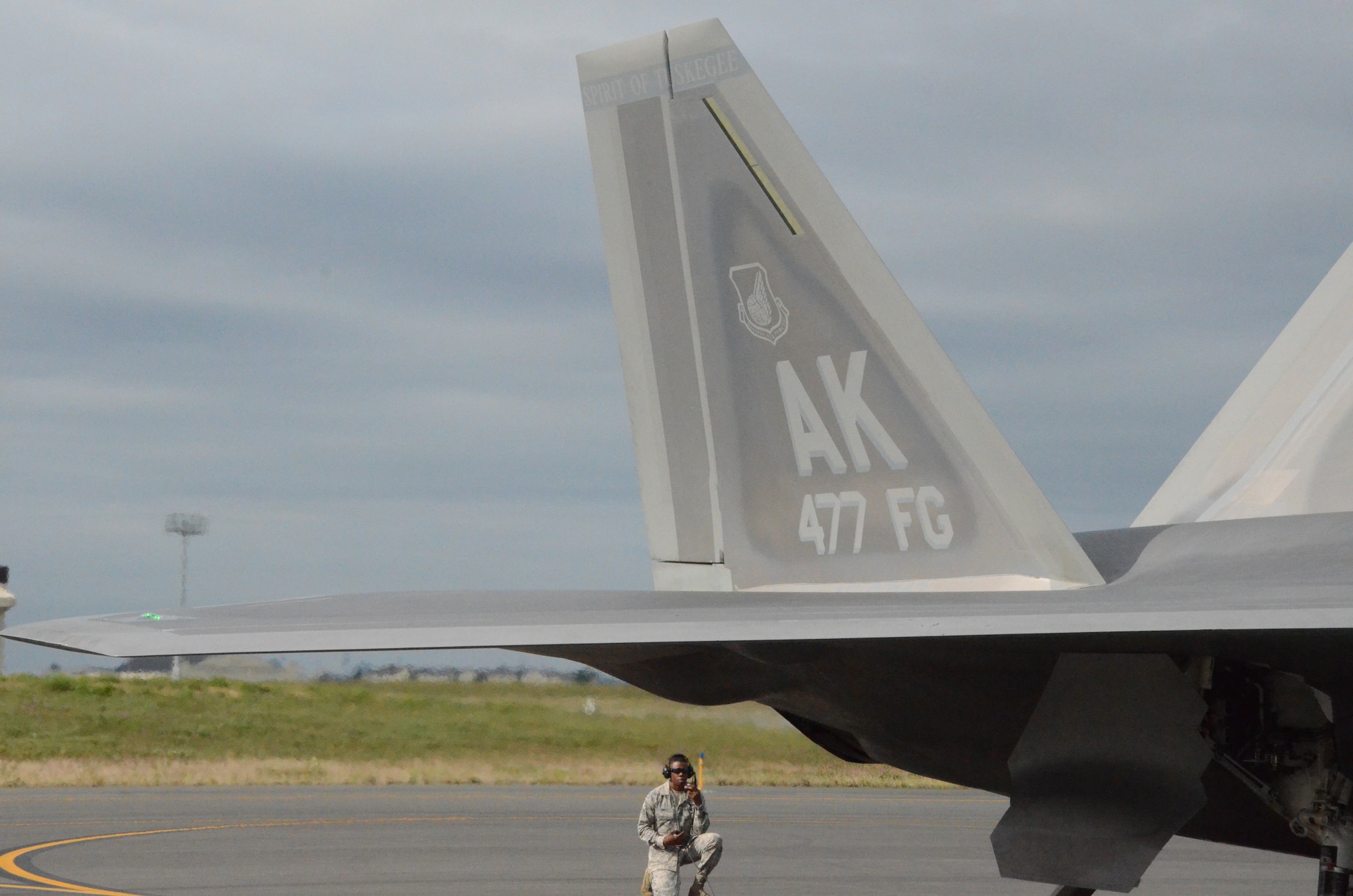 Airman 1st Class Jermaine James, 477th Aircraft Maintenance Squadron F-22 crew chief, prepares to launch an F-22 here July 31. This was the first time tail number 147 has flown after being transformed into the 477th Fighter Group flagship.  The words “Spirit of Tuskegee” painted across the tail, a nod to the units Tuskegee Airmen heritage.  The Reserve 477th Fighter Group was previously the 477th Bombardment Group, a Tuskegee unit activated in 1944. The group's 302nd Fighter Squadron historically was part of the 332nd Fighter Group, also known as "The Redtails" the famous all-black unit that fought both American prejudice and the axis powers in Europe.  (U.S. Air Force/ Tech. Sgt. Andy Eichorst)