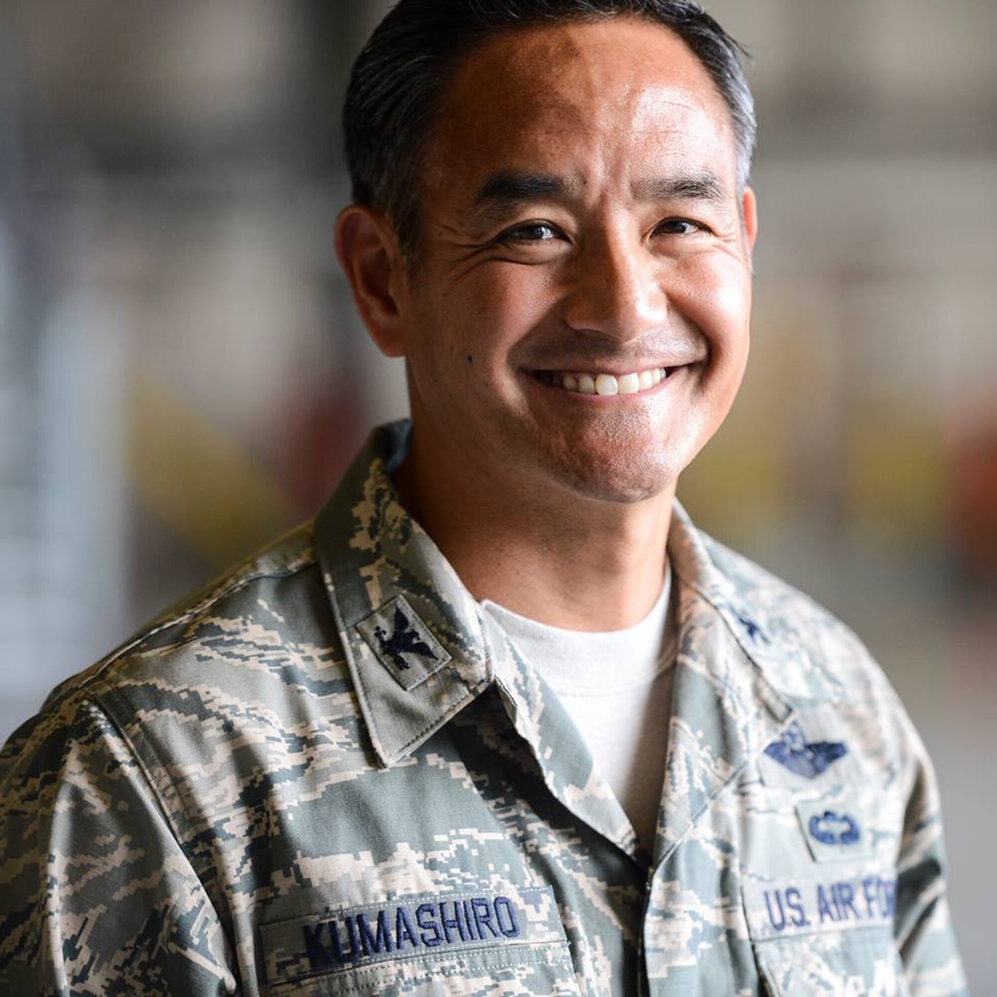 Col. David Kumashiro, 62nd Airlift Wing commander, pauses for a social media photo after his change of command ceremony, July 17, 2013 at Joint Base Lewis-McChord, Wash. Kumashiro has created his own 62nd AW commander Facebook page in order to highlight Airmen from JBLM. His page can be found at www.facebook.com/62ndAirliftWingCommander (U.S. Air Force photo/Tech. Sgt. Sean Tobin)
