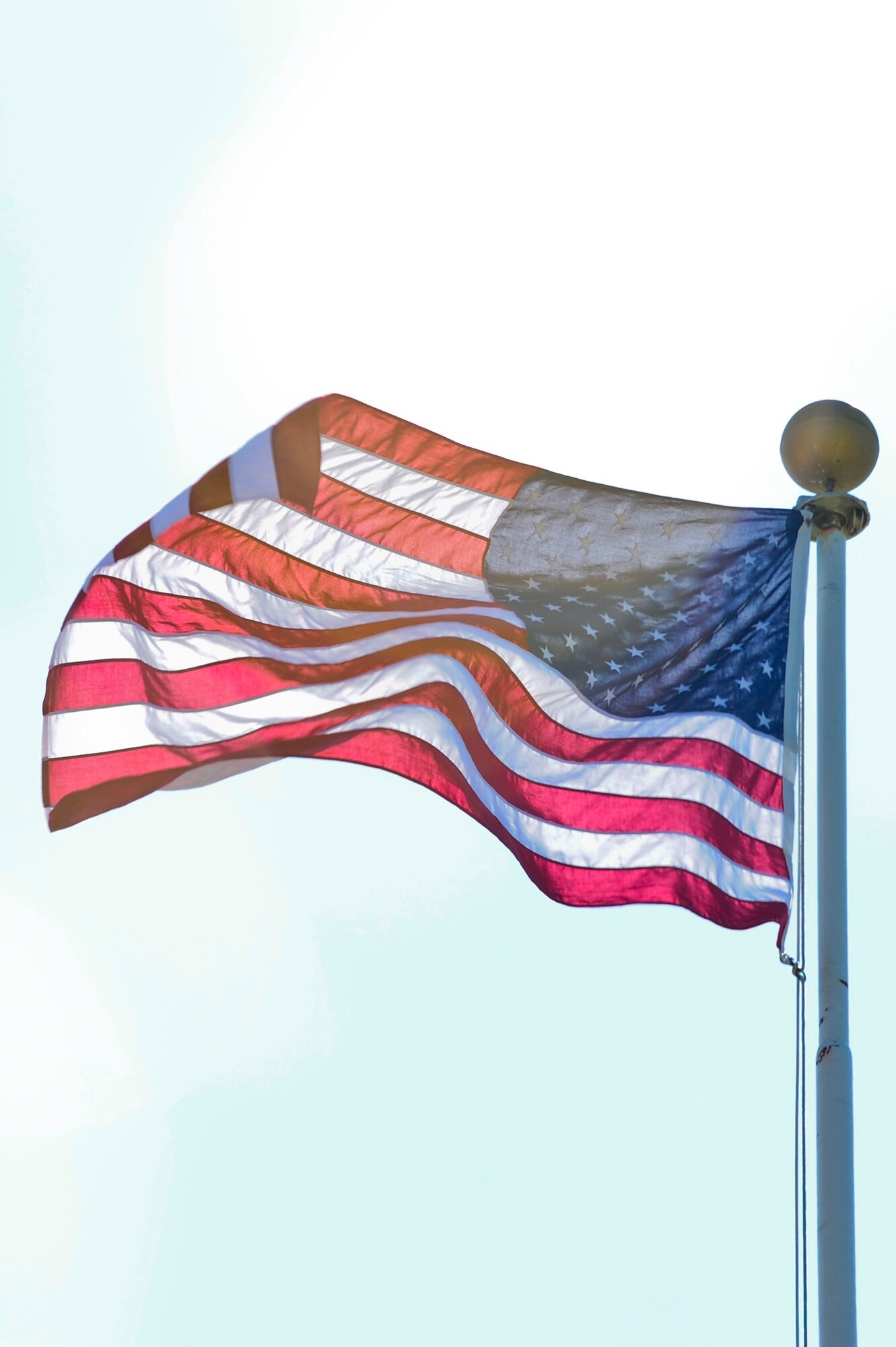 VANDENBERG AIR FORCE BASE, Calif. – The U.S. flag waves proudly at the top of the headquarters flagpole before the start of a retreat ceremony here Wednesday, July 31, 2013. The retreat ceremony became prominent after the Revolutionary War when the American Army would sound “retreat” at sunset every night. The call now announces the end of the duty day when the U.S. flag is lowered and retired for the evening. (U.S. Air Force photo/Senior Airman Lael Huss)