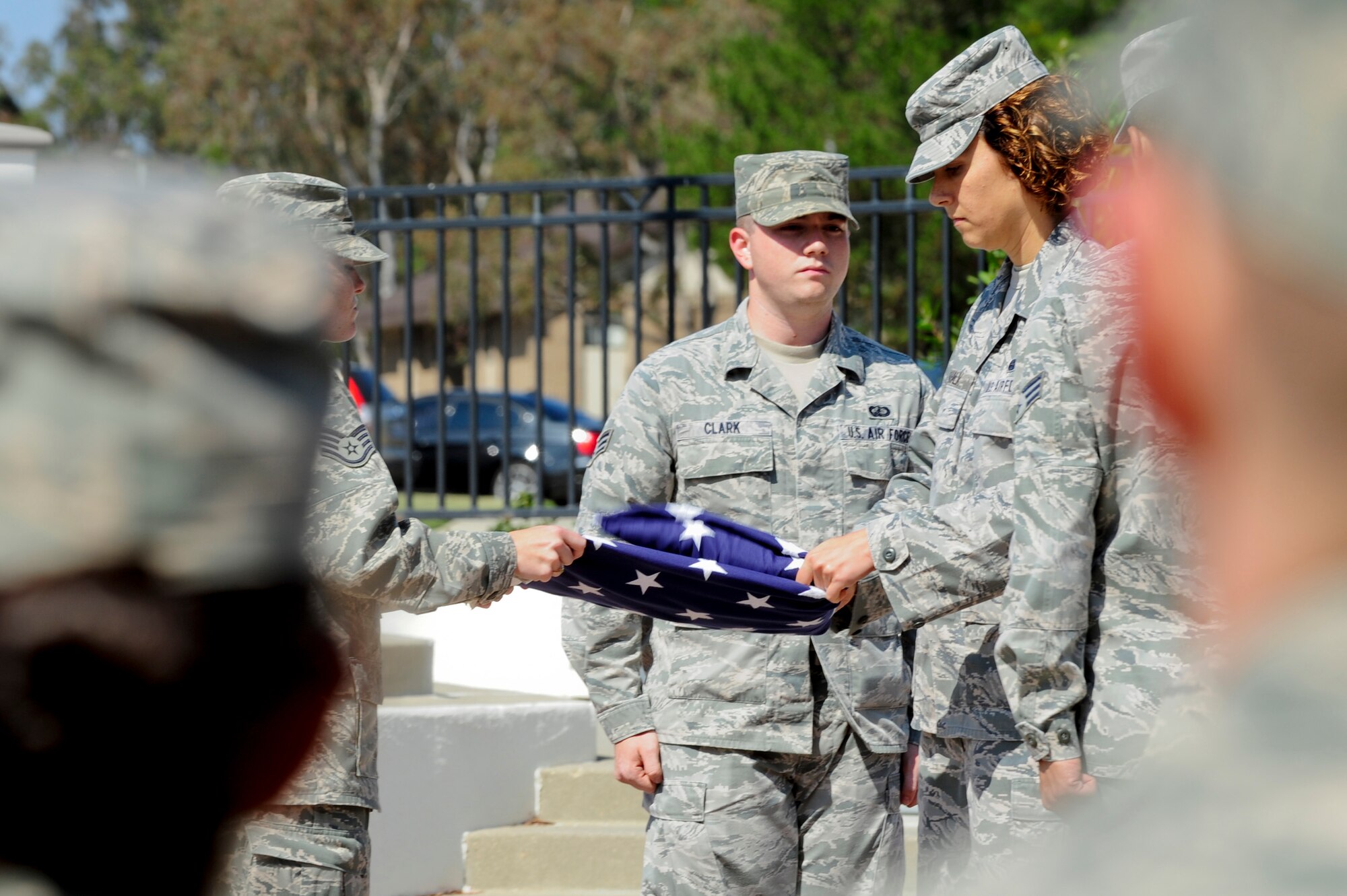 VANDENBERG AIR FORCE BASE, Calif. – Staff Sgt. Jennifer Vahalik, 30th Space Wing chaplains assistant and honor guard member, folds the U.S. flag during a retreat ceremony at the headquarters flagpole here Wednesday, July 31, 2013. The retreat ceremony became prominent after the Revolutionary War when the American Army would sound “retreat” at sunset every night. The call now announces the end of the duty day when the U.S. flag is lowered and retired for the evening. (U.S. Air Force photo/Senior Airman Lael Huss)