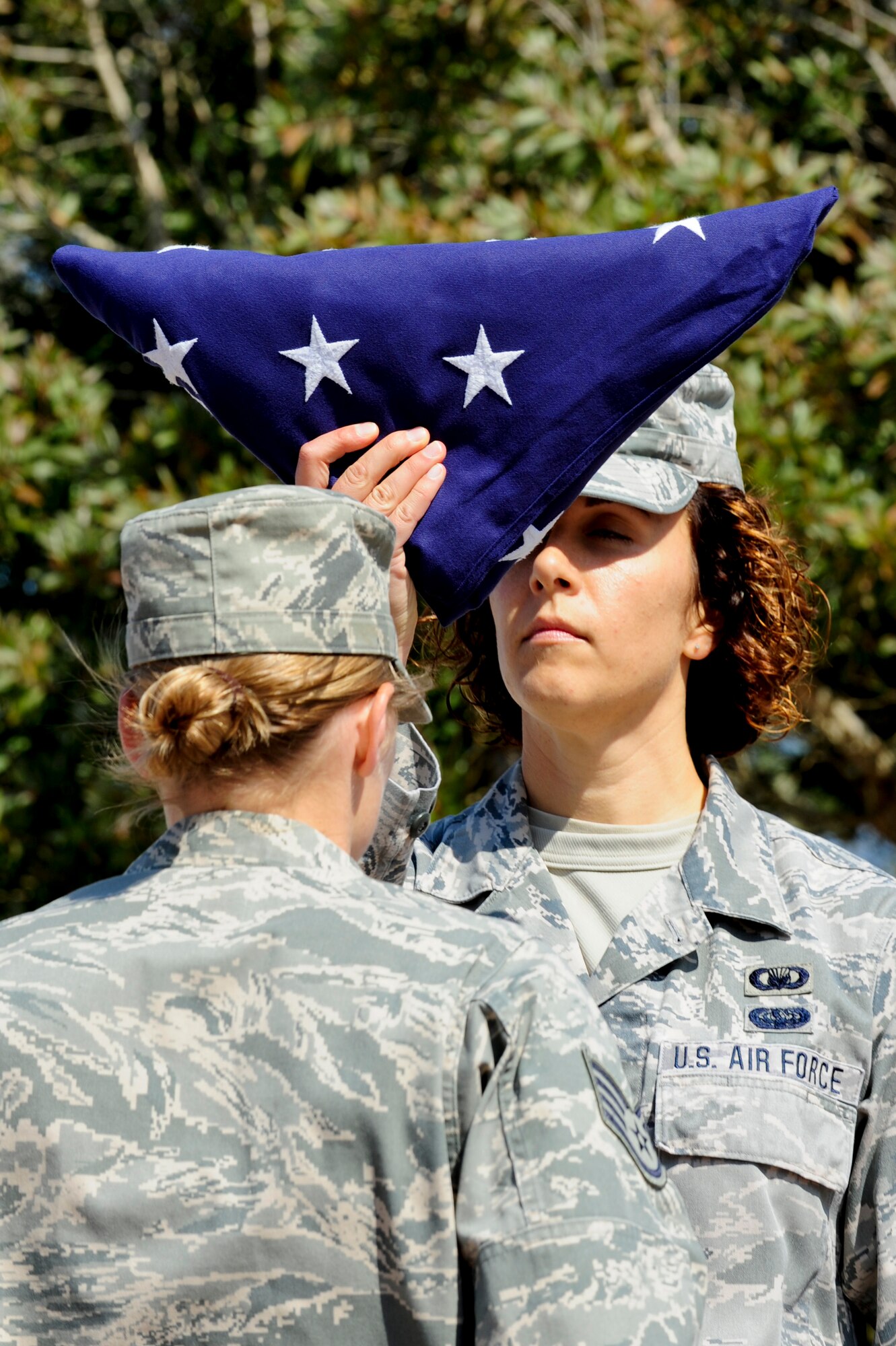 VANDENBERG AIR FORCE BASE, Calif. – Staff Sgt. Jennifer Vahalik, 30th Space Wing chaplains assistant, presents the folded flag during a retreat ceremony at the headquarters flagpole here Wednesday, July 31, 2013. The retreat ceremony became prominent after the Revolutionary War when the American Army would sound “retreat” at sunset every night. The call now announces the end of the duty day when the U.S. flag is lowered and retired for the evening. (U.S. Air Force photo/Senior Airman Lael Huss)