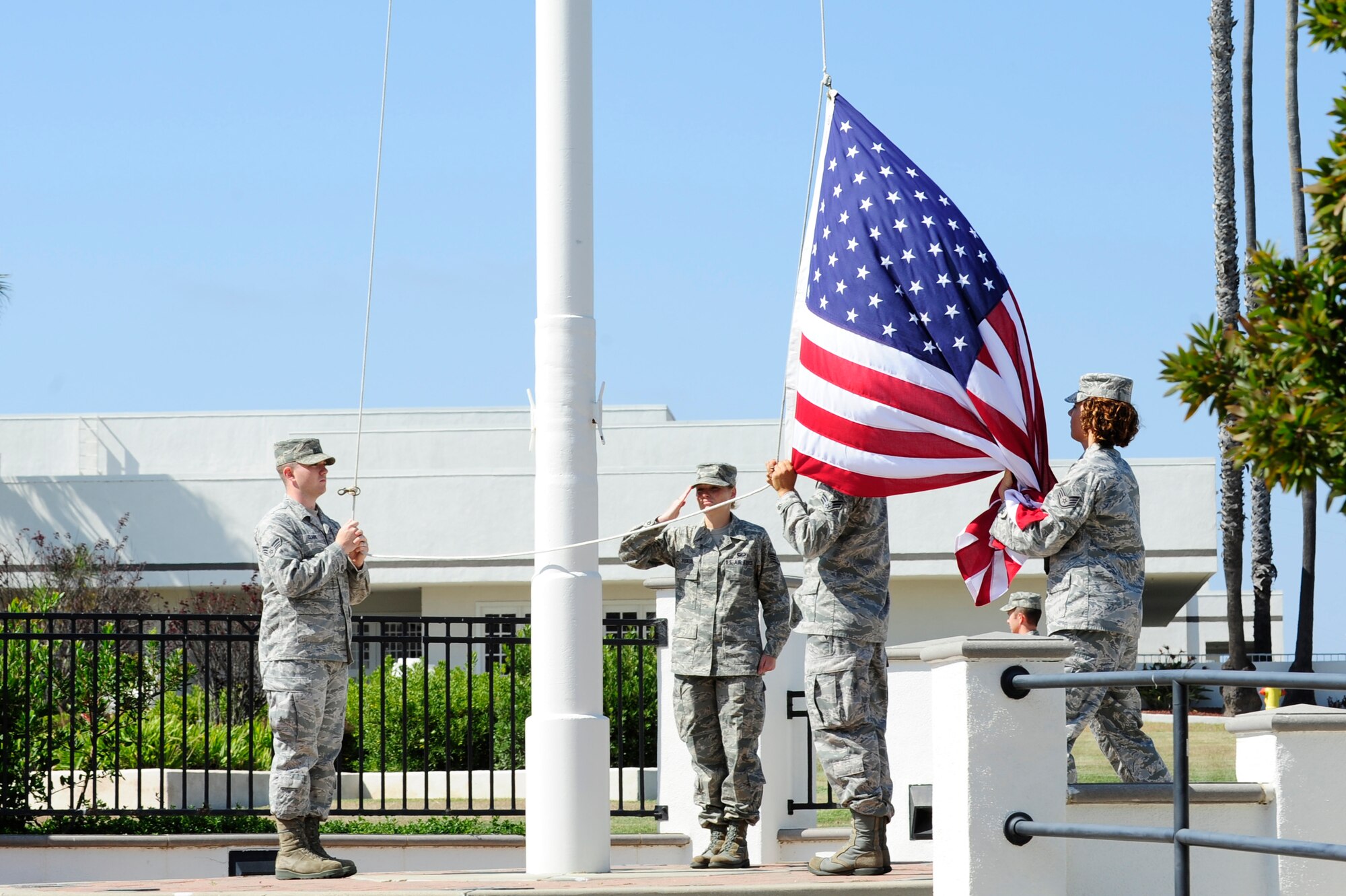 VANDENBERG AIR FORCE BASE, Calif. – Members of the 30th Space Wing wing staff agencies honor guard perform a retreat ceremony at the headquarters flagpole here Wednesday, July 31, 2013. The retreat ceremony became prominent after the Revolutionary War when the American Army would sound “retreat” at sunset every night. The call now announces the end of the duty day when the U.S. flag is lowered and retired for the evening. (U.S. Air Force photo/Senior Airman Lael Huss)