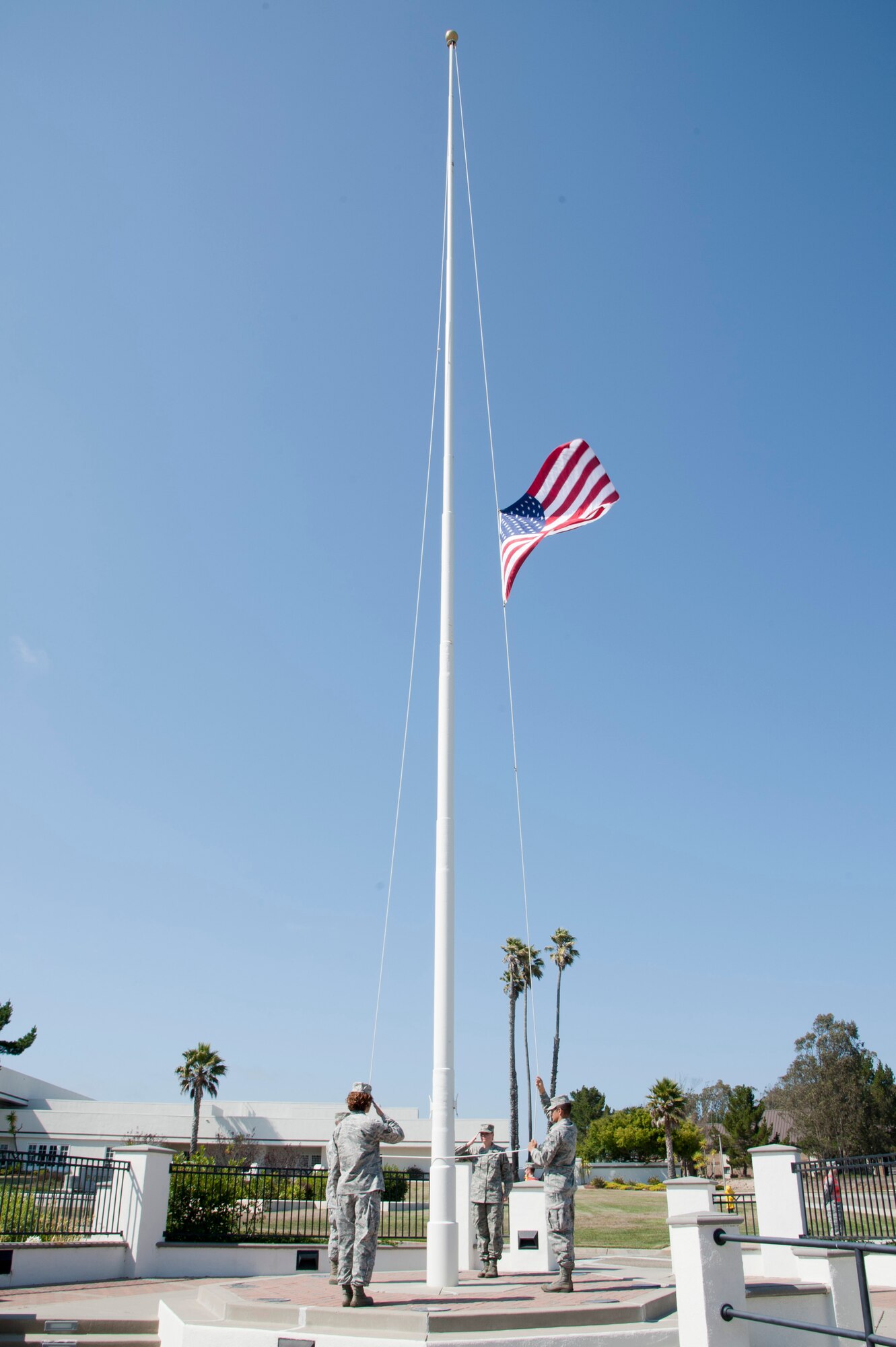 VANDENBERG AIR FORCE BASE, Calif. – Members of the 30th Space Wing wing staff agencies honor guard lower the flag during a retreat ceremony at the headquarters flagpole here Wednesday, July 31, 2013. The retreat ceremony became prominent after the Revolutionary War when the American Army would sound retreat at sunset every night. The call now announces the end of the duty day when the U.S. flag is lowered and retired for the evening. (U.S. Air Force photo/Senior Airman Lael Huss)
