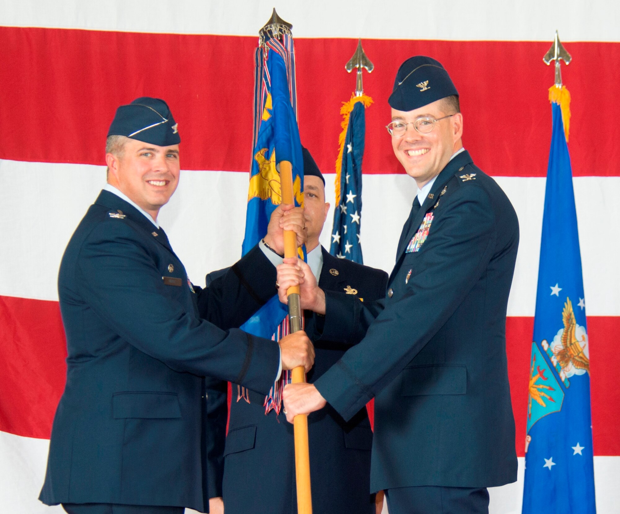 Colonel David Graff, 325th Fighter Wing commander, presents the 325th Mission Support Group  guidon to Col. Christopher Holmes during a change of command ceremony Aug. 2. (U.S. Air Force photo by Lisa Norman)