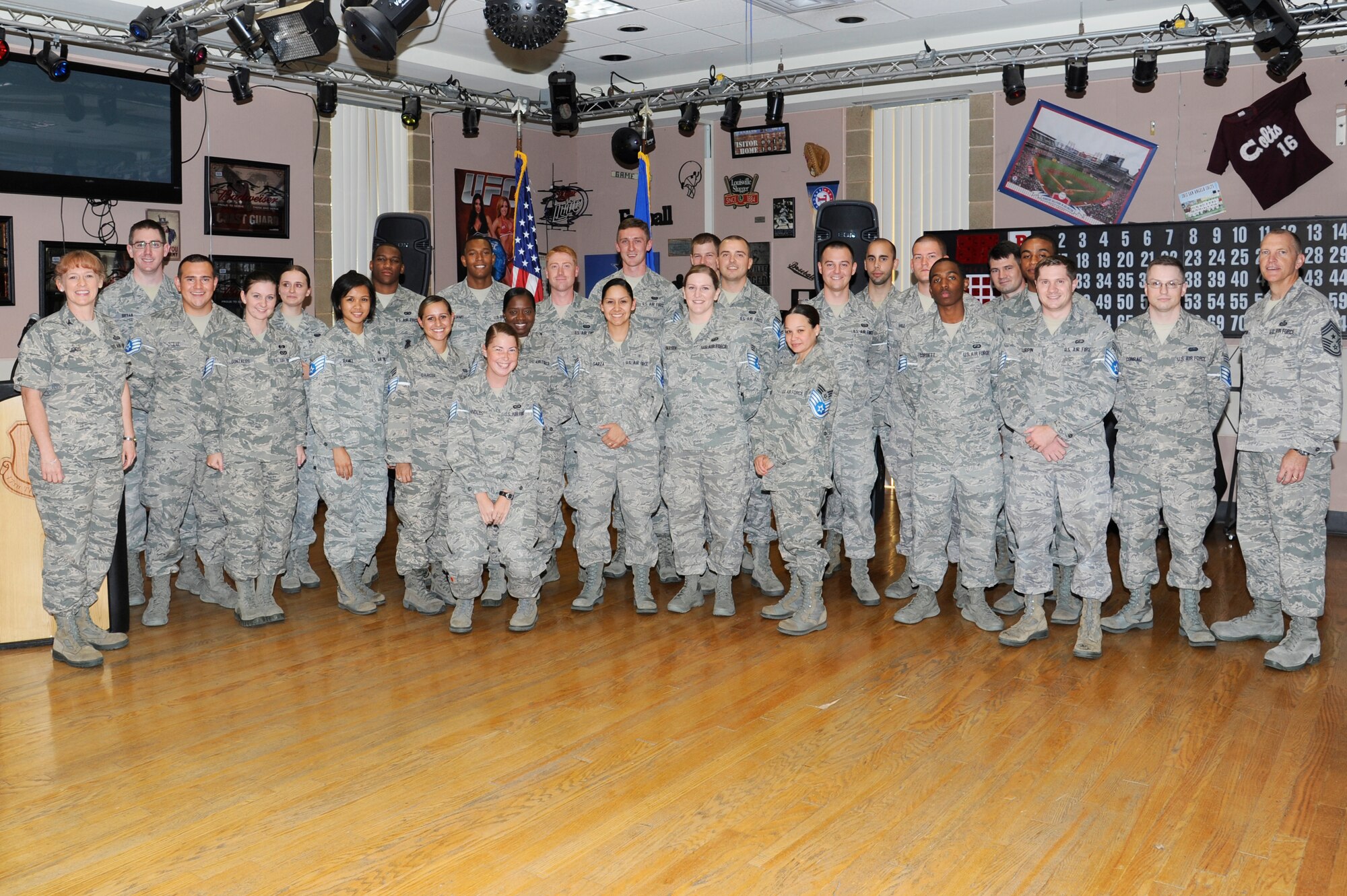 GOODFELLOW AIR FORCE BASE, Texas - Col. Kimberlee Joos, 17th Training Wing Commander, far left, and Chief Master Sgt. Scott Lumpkin, 17th TRW command chief, far right, stand for a group photo with the newest staff sergeant selects during the staff sergeant release ceremony July 1. (U.S. Air Force photo/ Staff Sgt. Austin Knox)