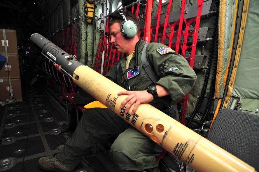 Tech. Sgt. Christopher Becvar, 53rd Weather Reconnaissance Squadron weather reconnaissance loadmaster, prepares an airborne expendable bathythermograph for release out of the back of a WC-130J aircraft during a flight into the remnants of Dorian July 29, 2013. The Navy partnered with the Air Force for a third year of testing the AXBT, which is designed to gather temperature readings of a column of water to help improve the output of coupled storm models. The Hurricane Hunters flew a low-level investigation into Dorian to gather storm data used by the National Hurricane Center to determine whether the tropical wave was breaking up or reforming into a more intensified storm. (U.S. Air Force photo/Tech. Sgt. Ryan Labadens)