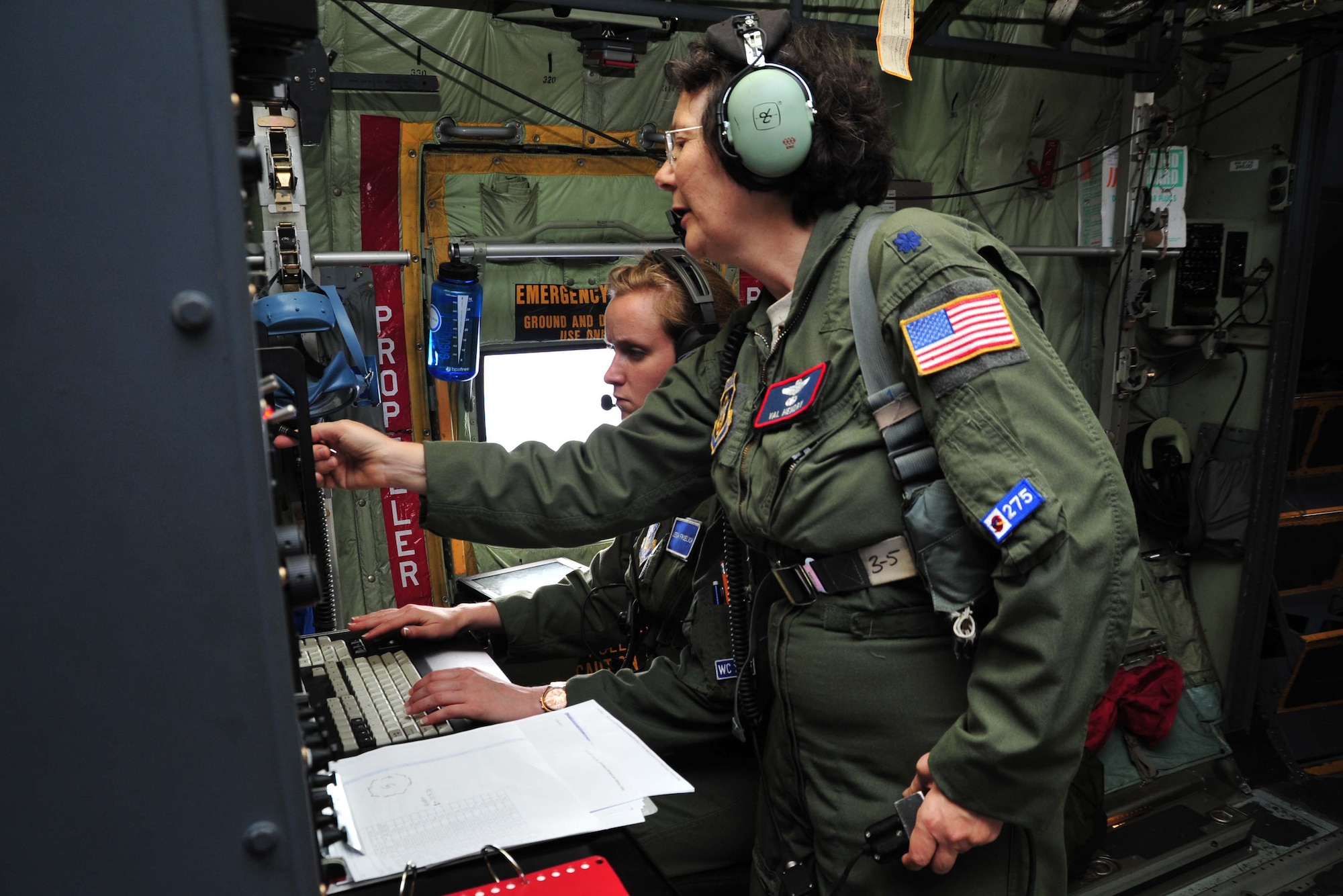 Lt. Col. Valerie Hendry, 53rd Weather Reconnaissance Squadron aerial reconnaissance weather officer, instructs 2nd Lt. Leesa Froelich, 53rd WRS ARWO, during the lieutenant’s first storm mission with the Hurricane Hunters. The Hurricane Hunters flew a low-level investigation into Dorian to gather storm data used by the National Hurricane Center to determine whether the tropical wave was breaking up or reforming into a more intensified storm. (U.S. Air Force photo/Tech. Sgt. Ryan Labadens)